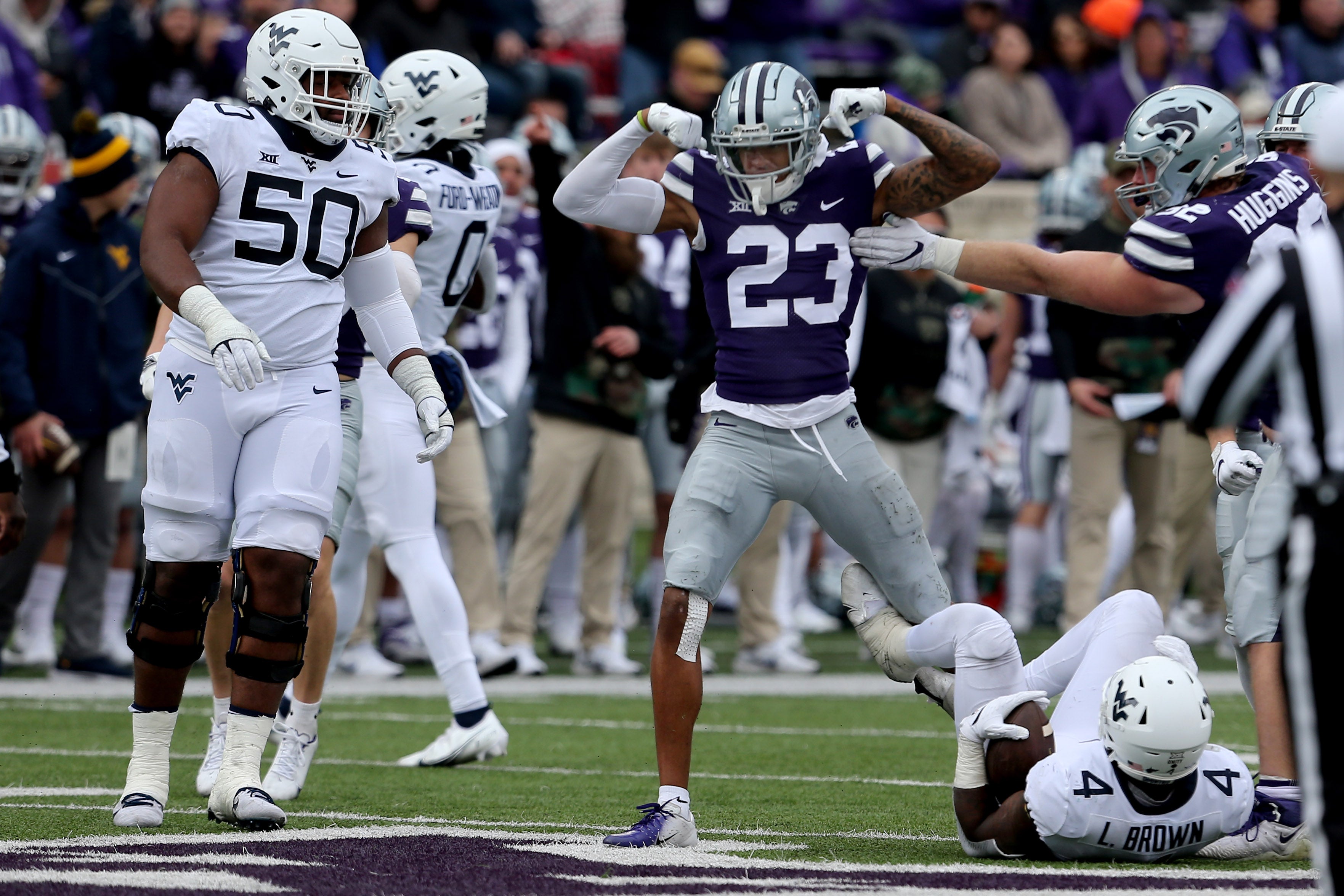 Nov 13, 2021; Manhattan, Kansas, USA; Kansas State Wildcats defensive back Julius Brents (23) celebrates the tackle of West Virginia Mountaineers running back Leddie Brown (4) during the third quarter at Bill Snyder Family Football Stadium.