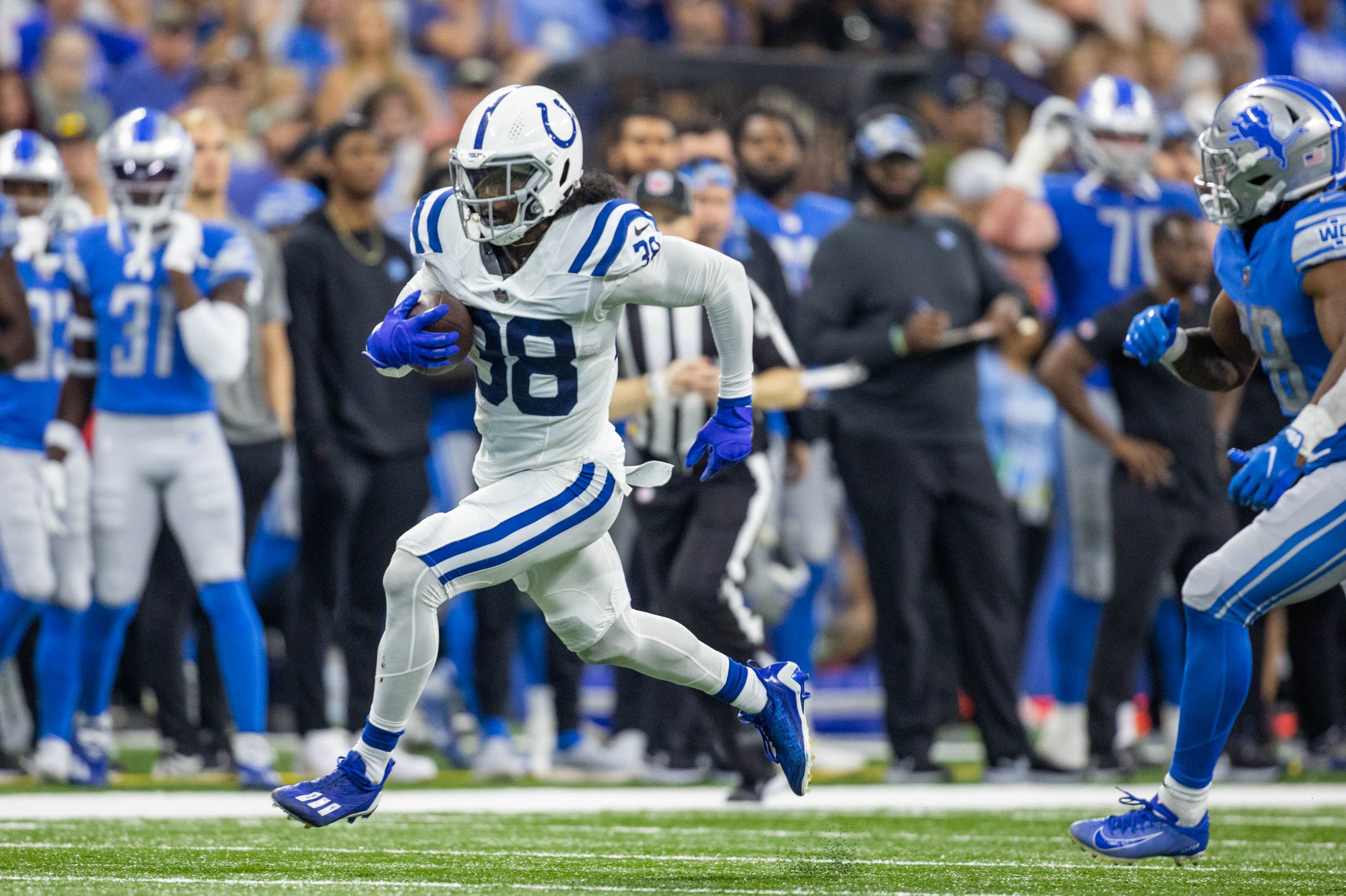 Aug 20, 2022; Indianapolis, Indiana, USA; Indianapolis Colts cornerback Tony Brown (38) runs with the ball after an interception in the second quarter against the Detroit Lions at Lucas Oil Stadium. Mandatory Credit: Trevor Ruszkowski-USA TODAY Sports