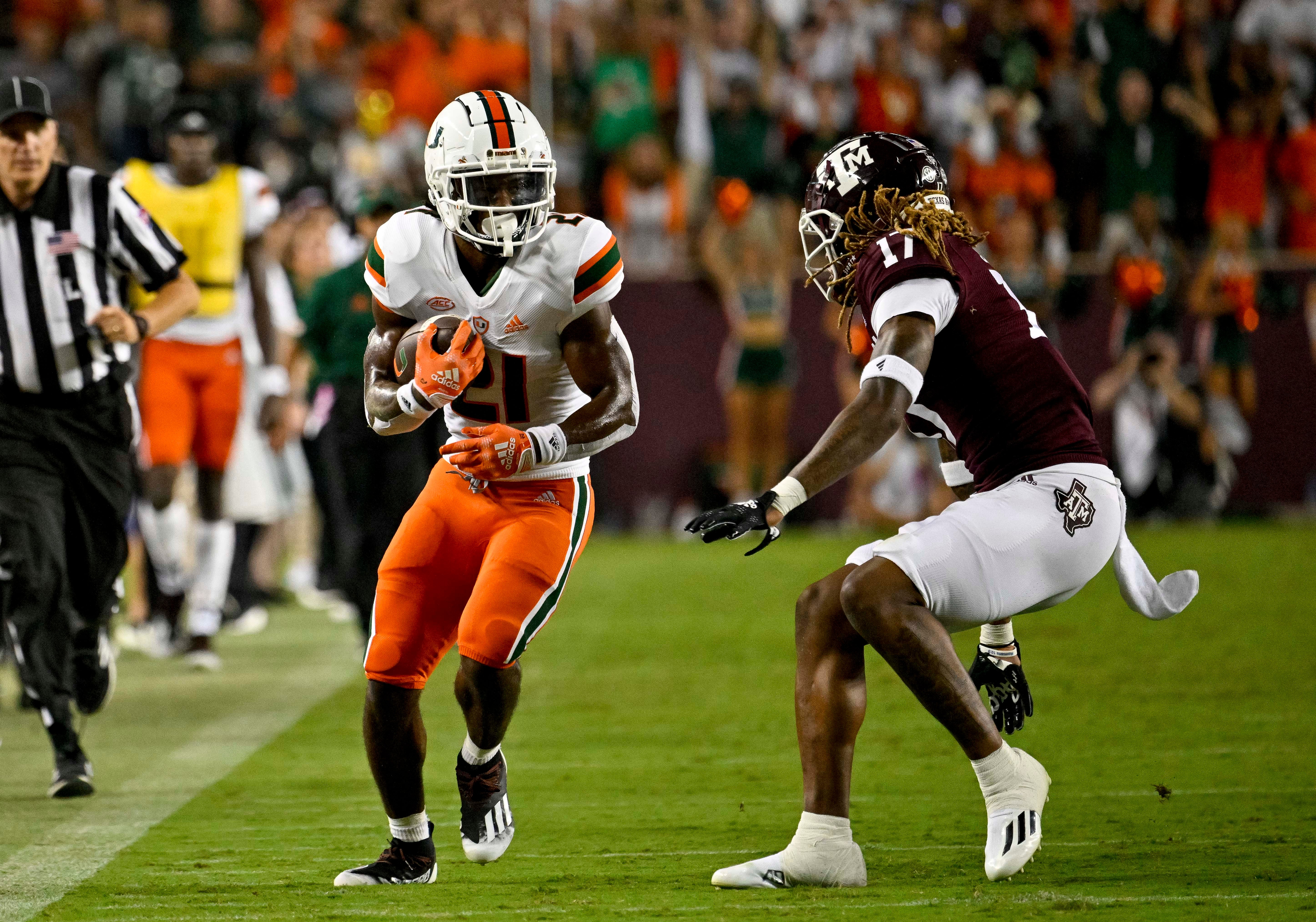 Sep 17, 2022; College Station, Texas, USA; Miami Hurricanes running back Henry Parrish Jr. (21) and Texas A&M Aggies defensive back Jaylon Jones (17) in action during the game between the Texas A&M Aggies and the Miami Hurricanes at Kyle Field. Mandatory Credit: Jerome Miron-USA TODAY Sports