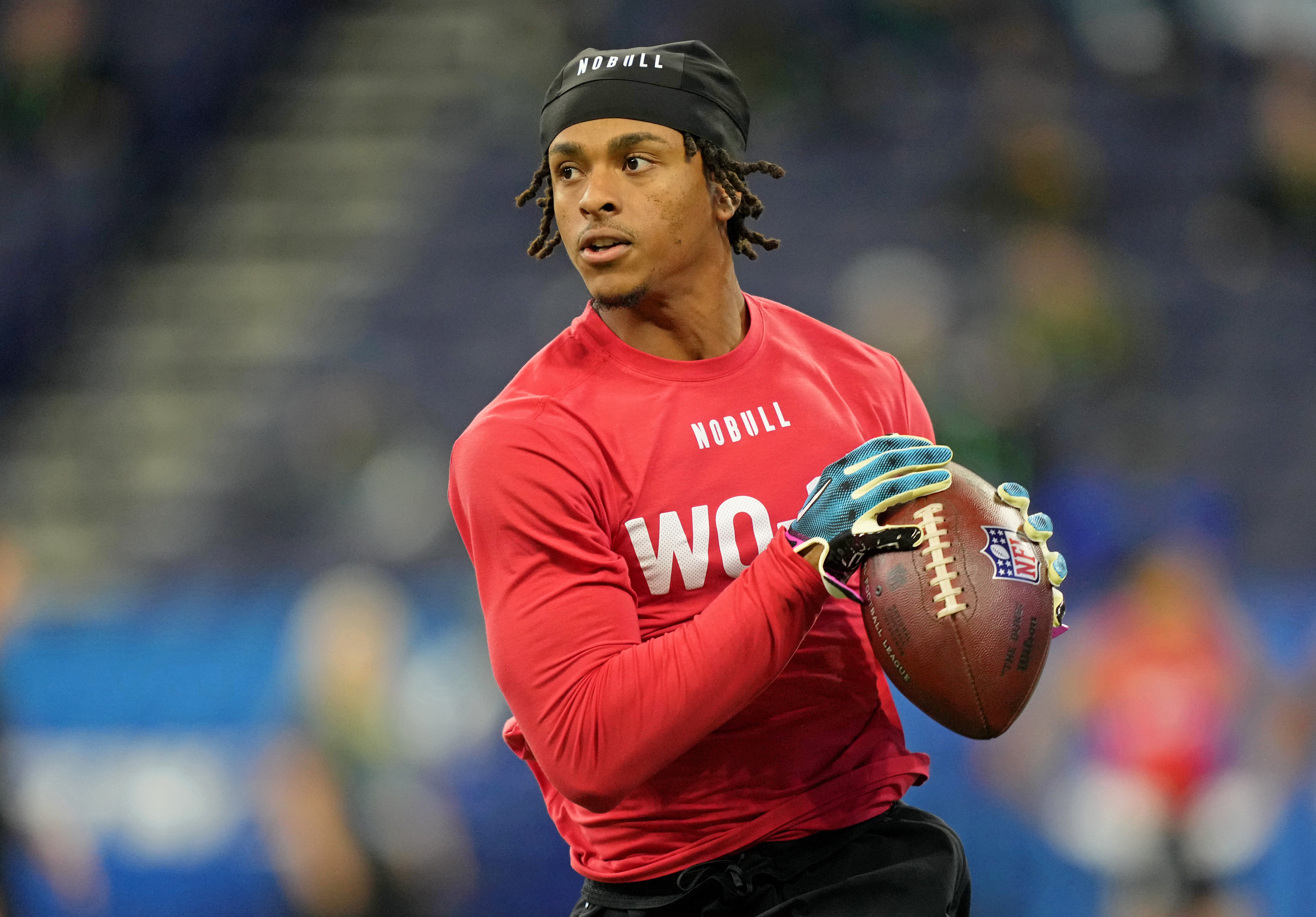 Mar 4, 2023; Indianapolis, IN, USA; North Carolina wide receiver Josh Downs (WO14) participates in drills at Lucas Oil Stadium.