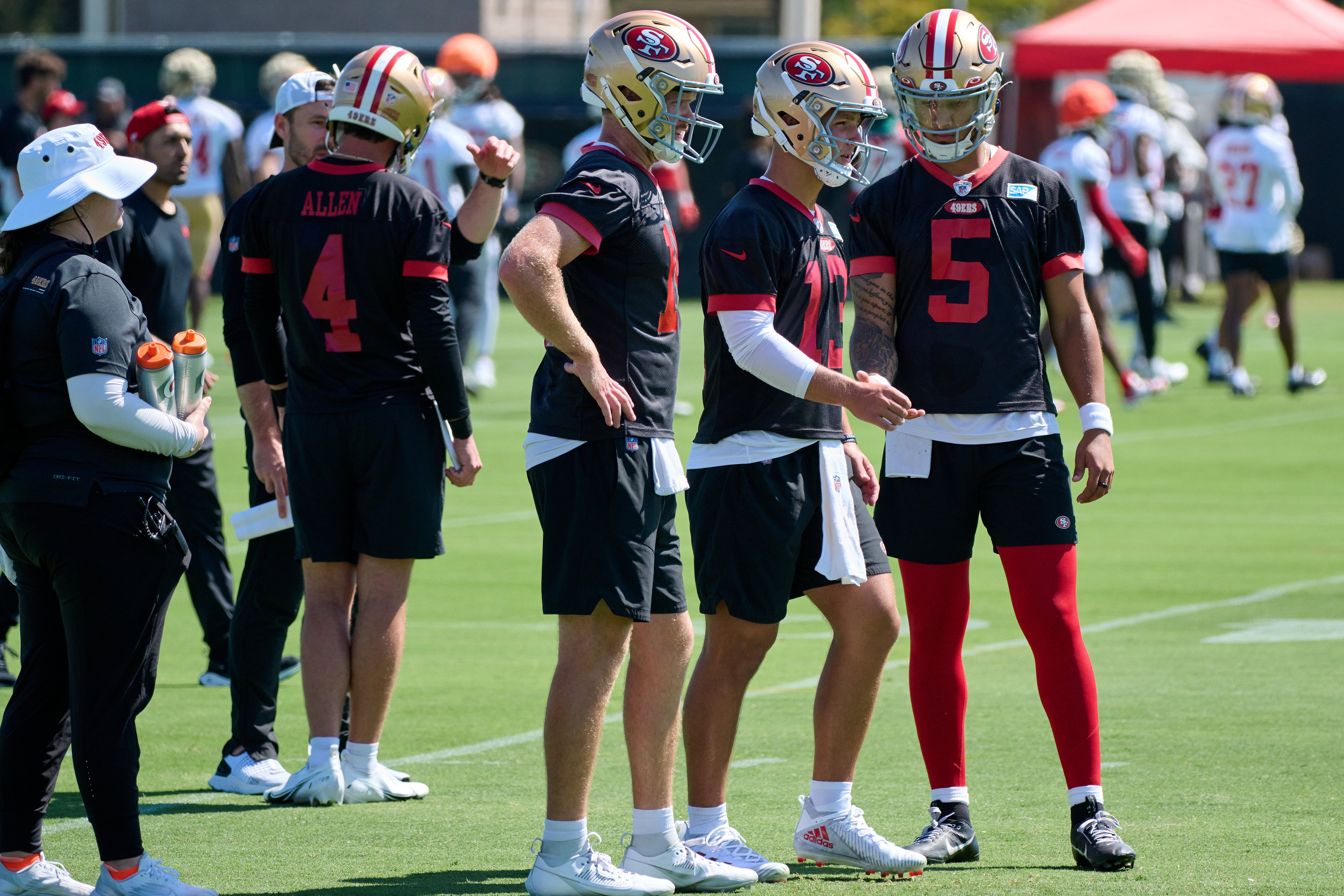 Jul 27, 2023; Santa Clara, CA, USA; San Francisco 49ers quarterbacks Brock Purdy (13) and Trey Lance (5) and Sam Darnold (14) and Brandon Allen (4) stand on the field during training camp at the SAP Performance Facility. Mandatory Credit: Robert Edwards-USA TODAY Sports