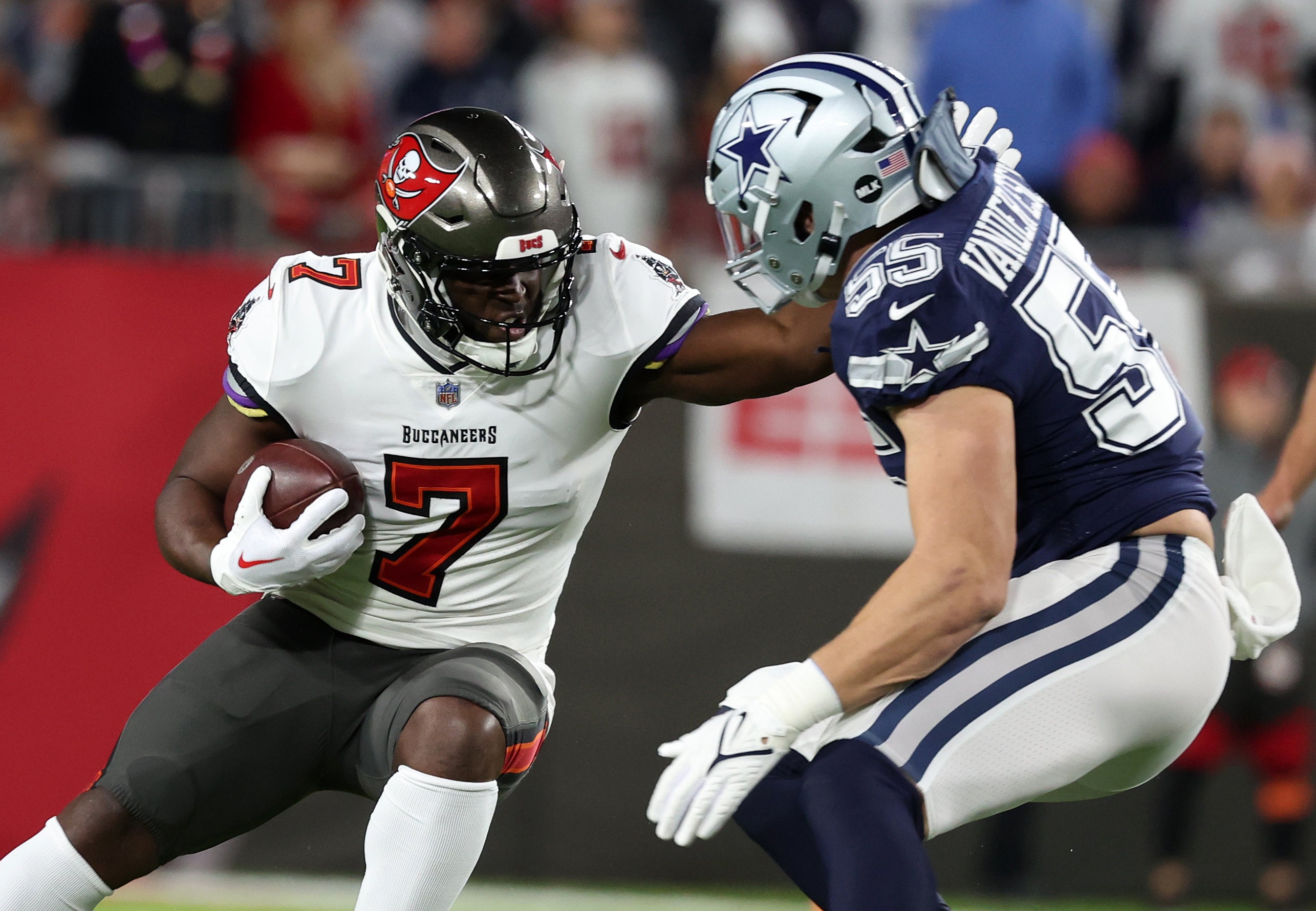 Jan 16, 2023; Tampa, Florida, USA; Tampa Bay Buccaneers running back Leonard Fournette (7) rushes the ball against the Dallas Cowboys linebacker Leighton Vander Esch (55) in the first half during the wild card game at Raymond James Stadium.