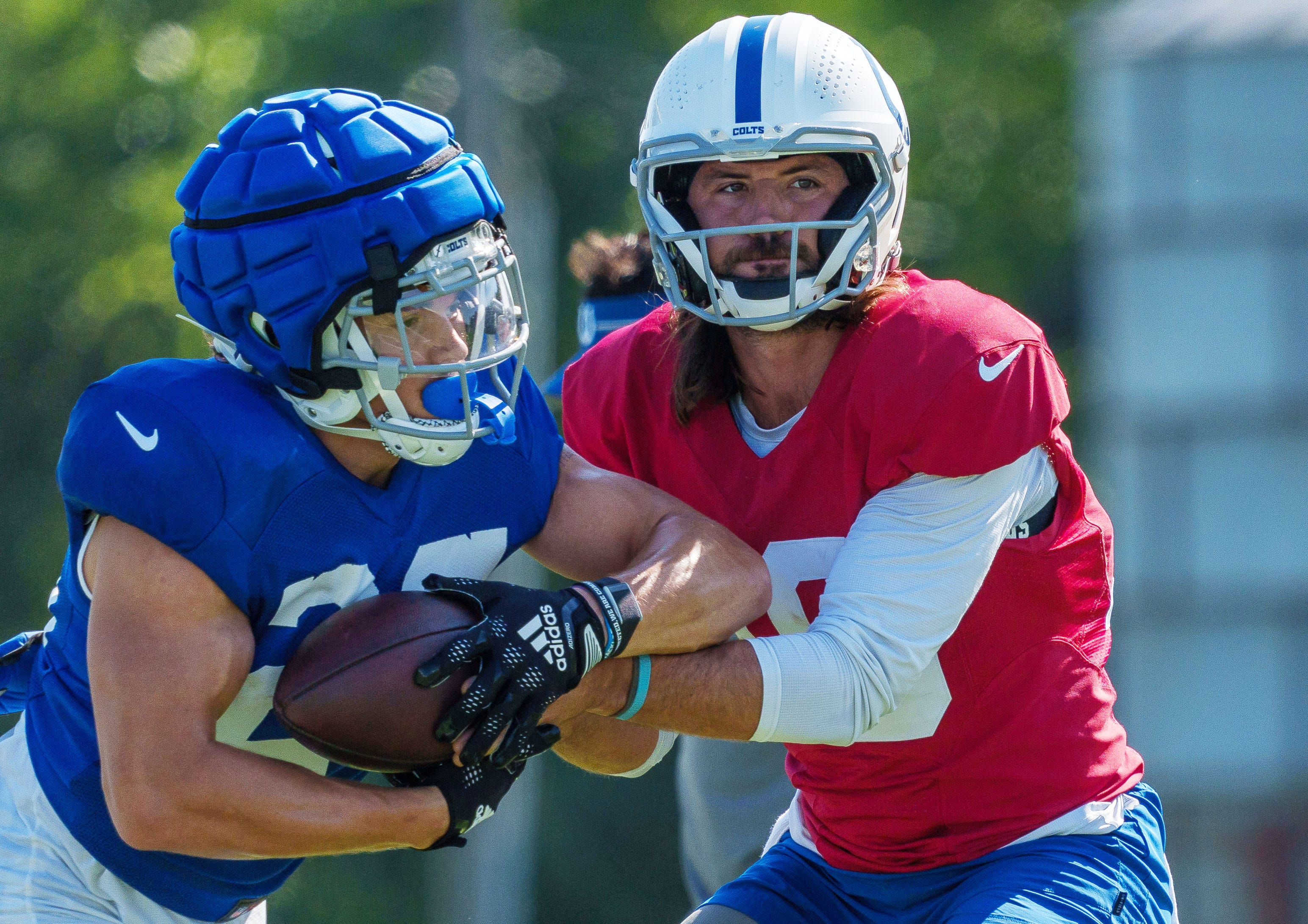 July 31: Indianapolis Colts quarterback Gardner Minshew hands off to running back Evan Hull.