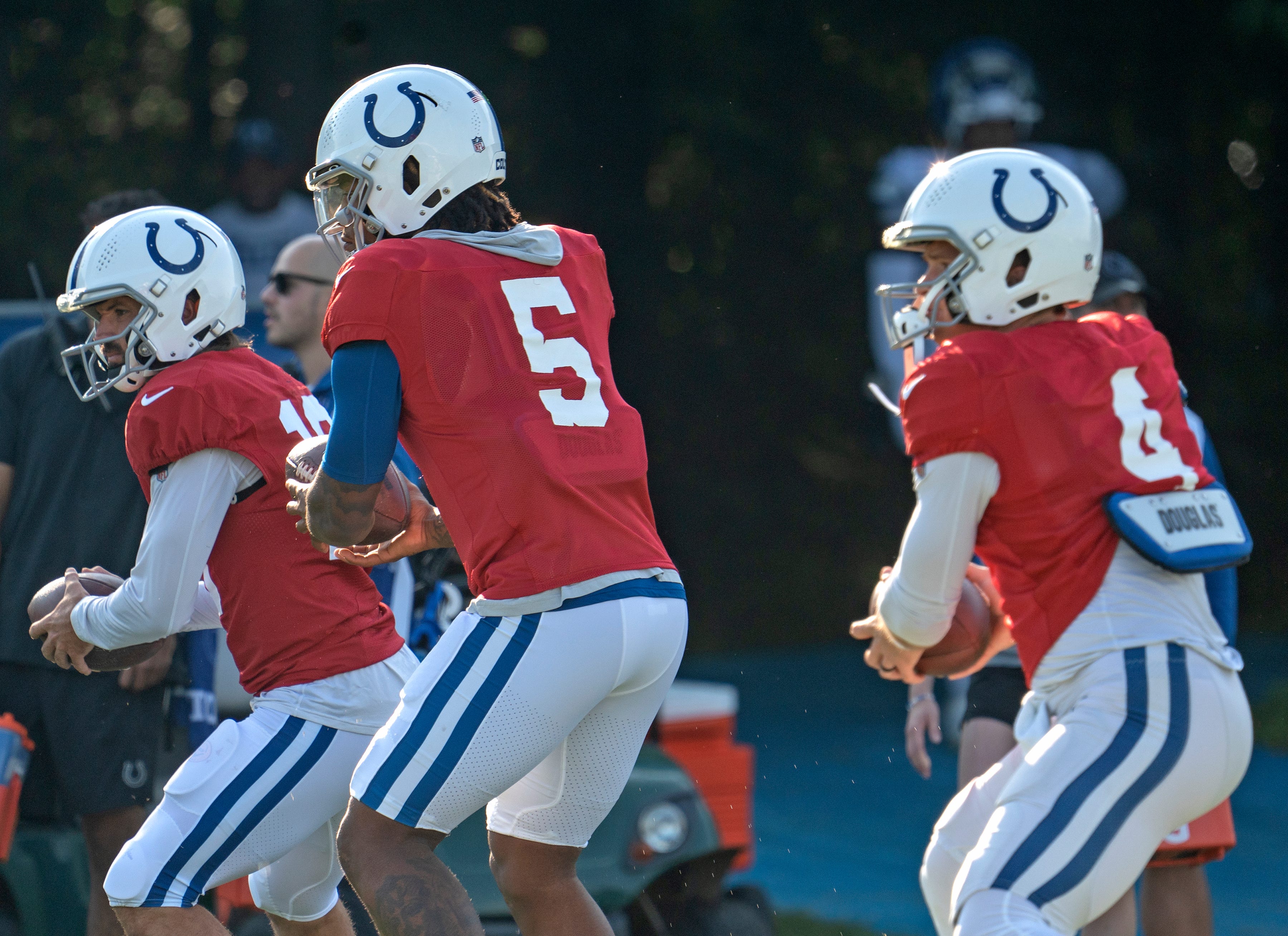 Indianapolis Colts quarterbacks Gardner Minshew II (10), Anthony Richardson (5), and Sam Ehlinger (4) run in sync during day 6 of Colts Camp, Thursday, Aug. 3, 2023 at Grand Park.