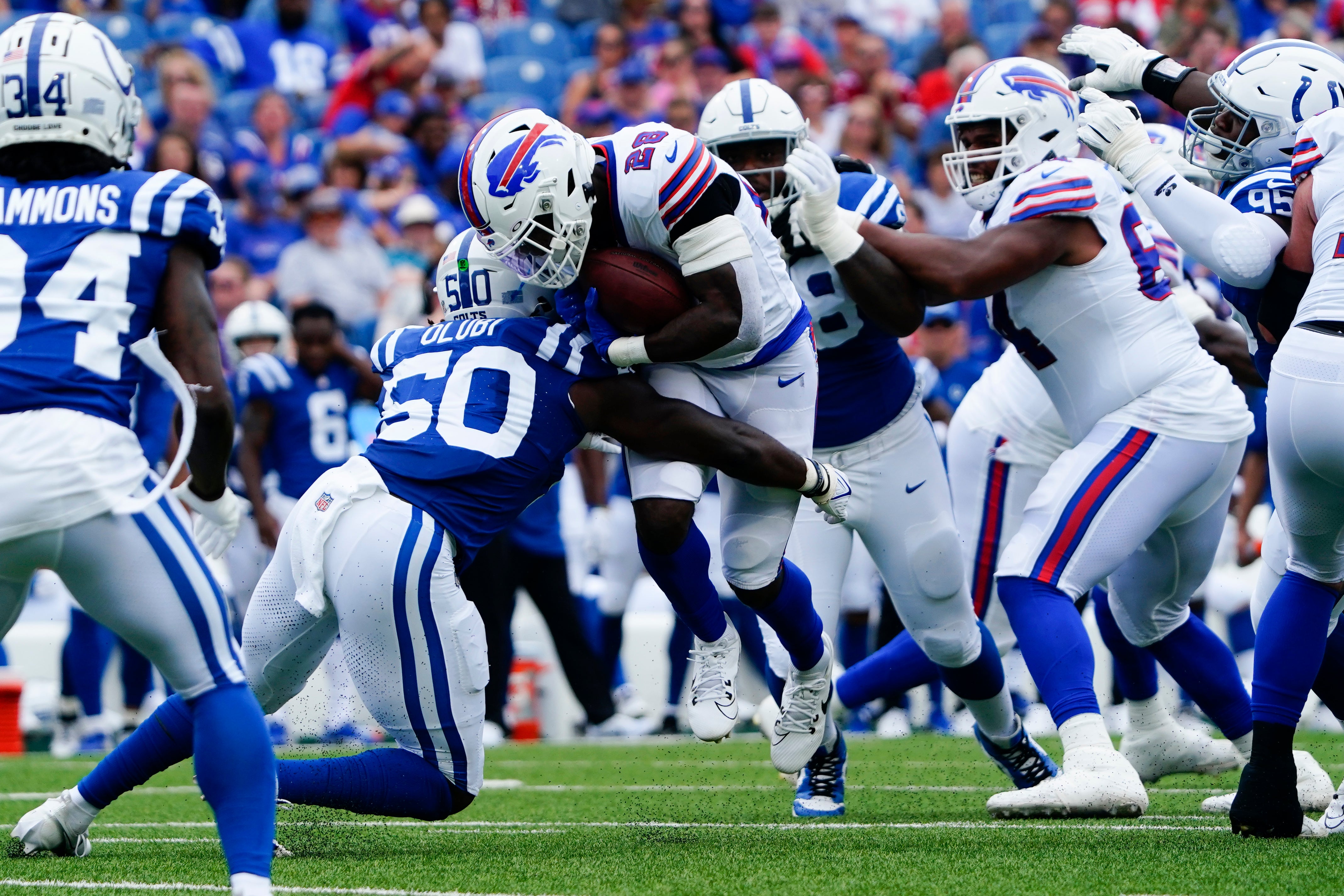 Aug 12, 2023; Orchard Park, New York, USA; Indianapolis Colts linebacker Segun Olubi (50) tackles Buffalo Bills running back Latavius Murray (28) running with the ball during the first half at Highmark Stadium.