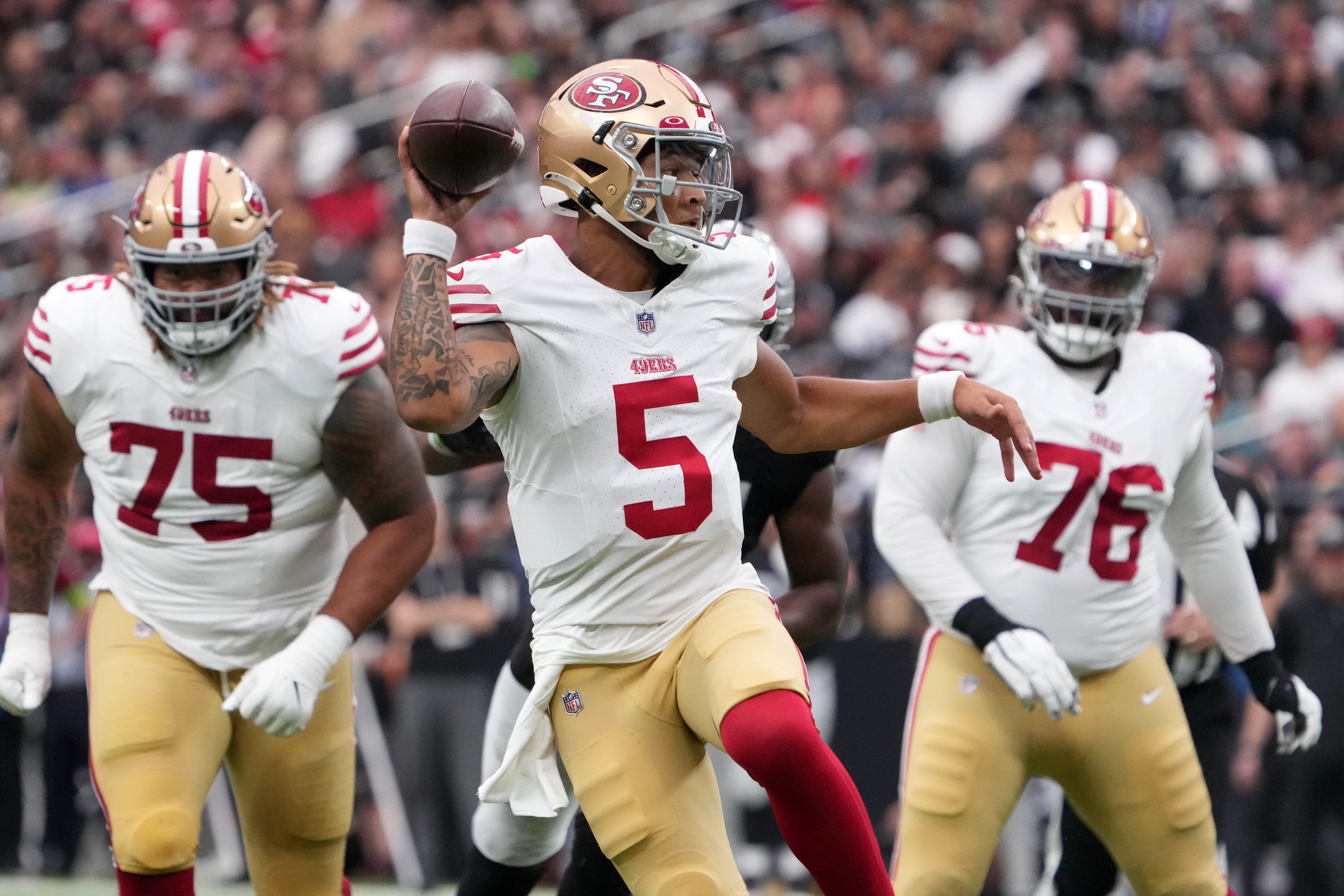 Aug 13, 2023; Paradise, Nevada, USA; San Francisco 49ers quarterback Trey Lance (5) throws a touchdown pass against the Las Vegas Raiders in the first half at Allegiant Stadium. Mandatory Credit: Kirby Lee-USA TODAY Sports