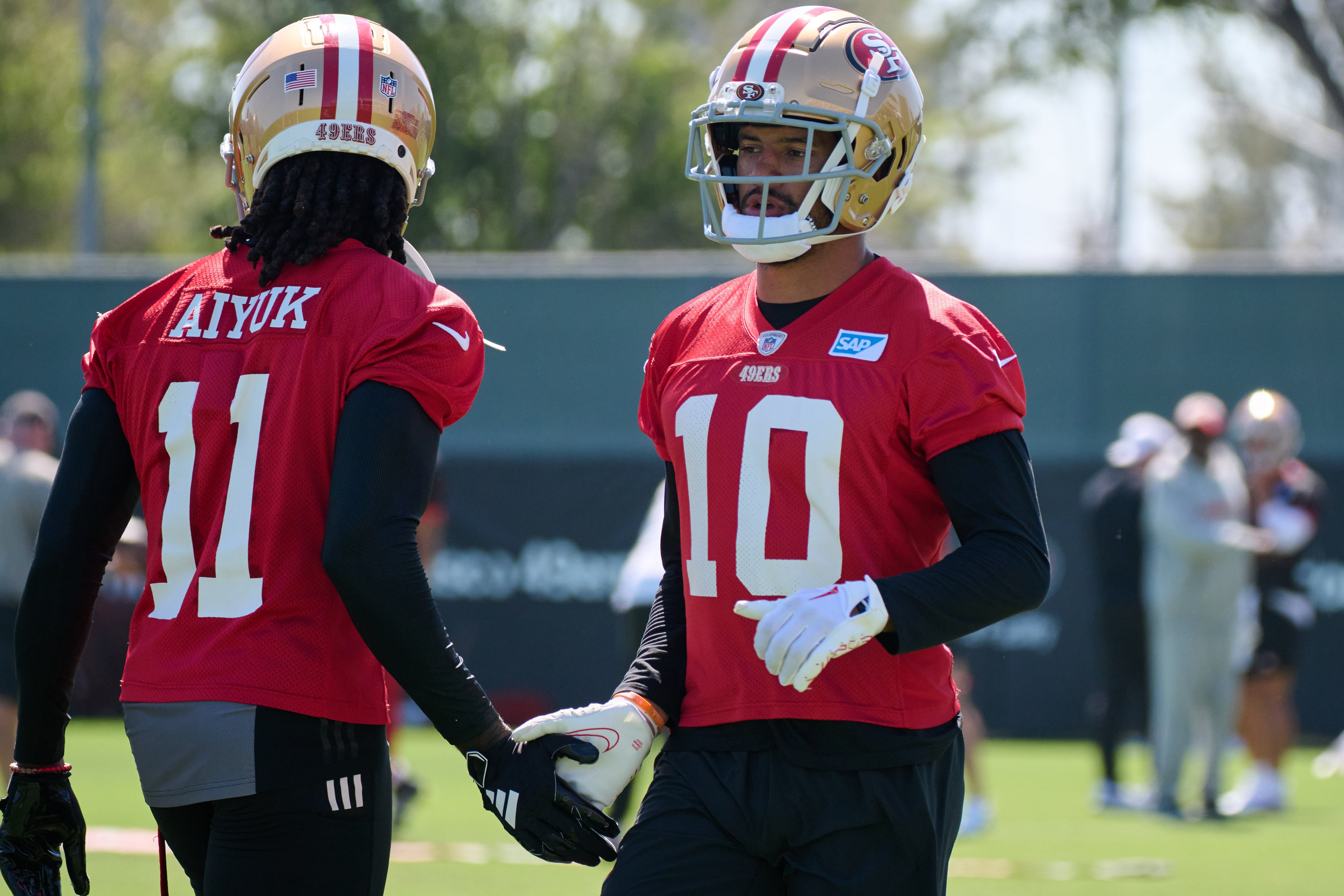 Jul 27, 2023; Santa Clara, CA, USA; San Francisco 49ers wide receiver Ronnie Bell (10) shakes hands with wide receiver Brandon Aiyuk (11) during training camp at the SAP Performance Facility. Mandatory Credit: Robert Edwards-USA TODAY Sports