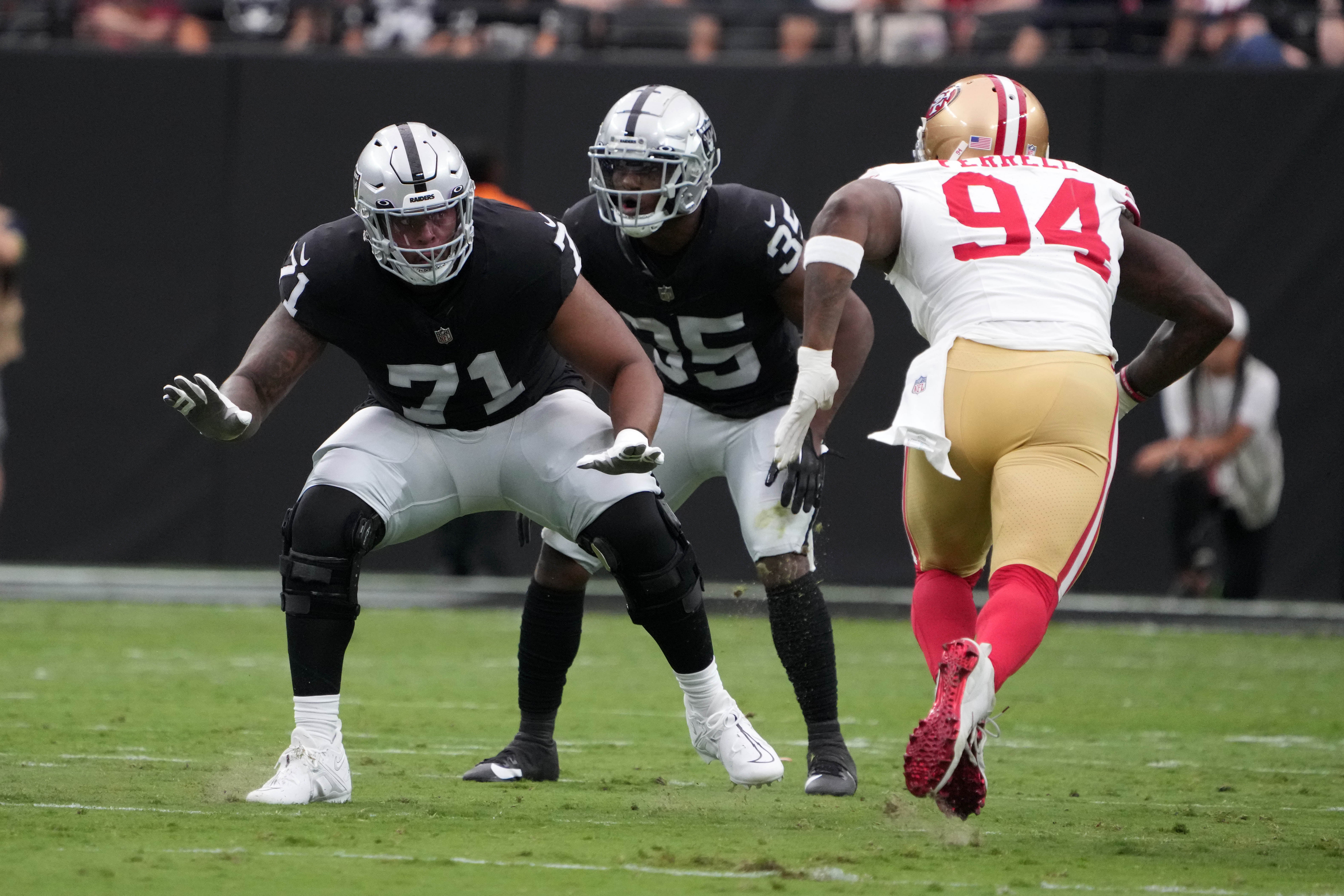 Aug 13, 2023; Paradise, Nevada, USA; Las Vegas Raiders offensive tackle Justin Herron (71) defends against San Francisco 49ers defensive end Clelin Ferrell (94) in the first half at Allegiant Stadium. Mandatory Credit: Kirby Lee-USA TODAY Sports