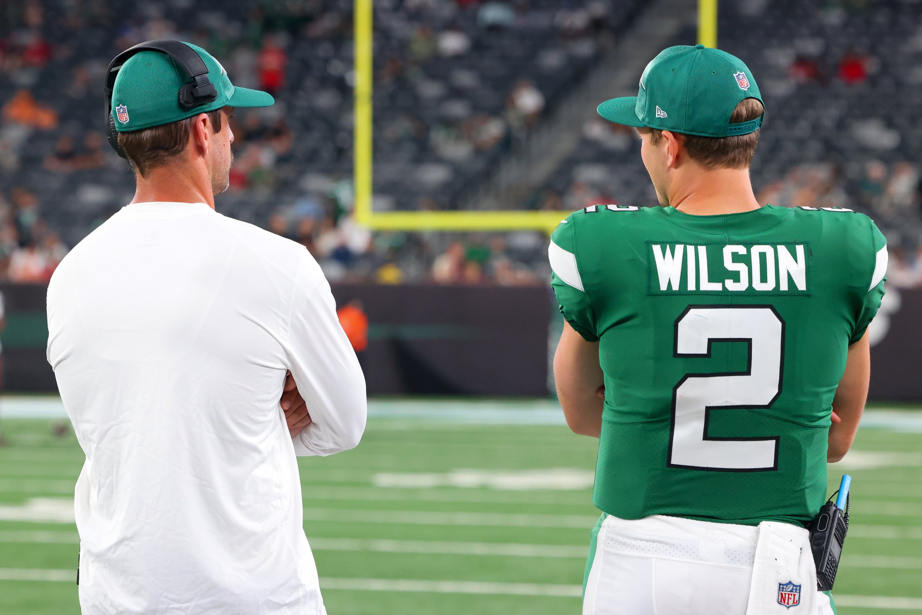 East Rutherford, New Jersey, USA; New York Jets quarterback Aaron Rodgers (8) and New York Jets quarterback Zach Wilson (2) talk during the second half of their game against the Tampa Bay Buccaneers at MetLife Stadium.