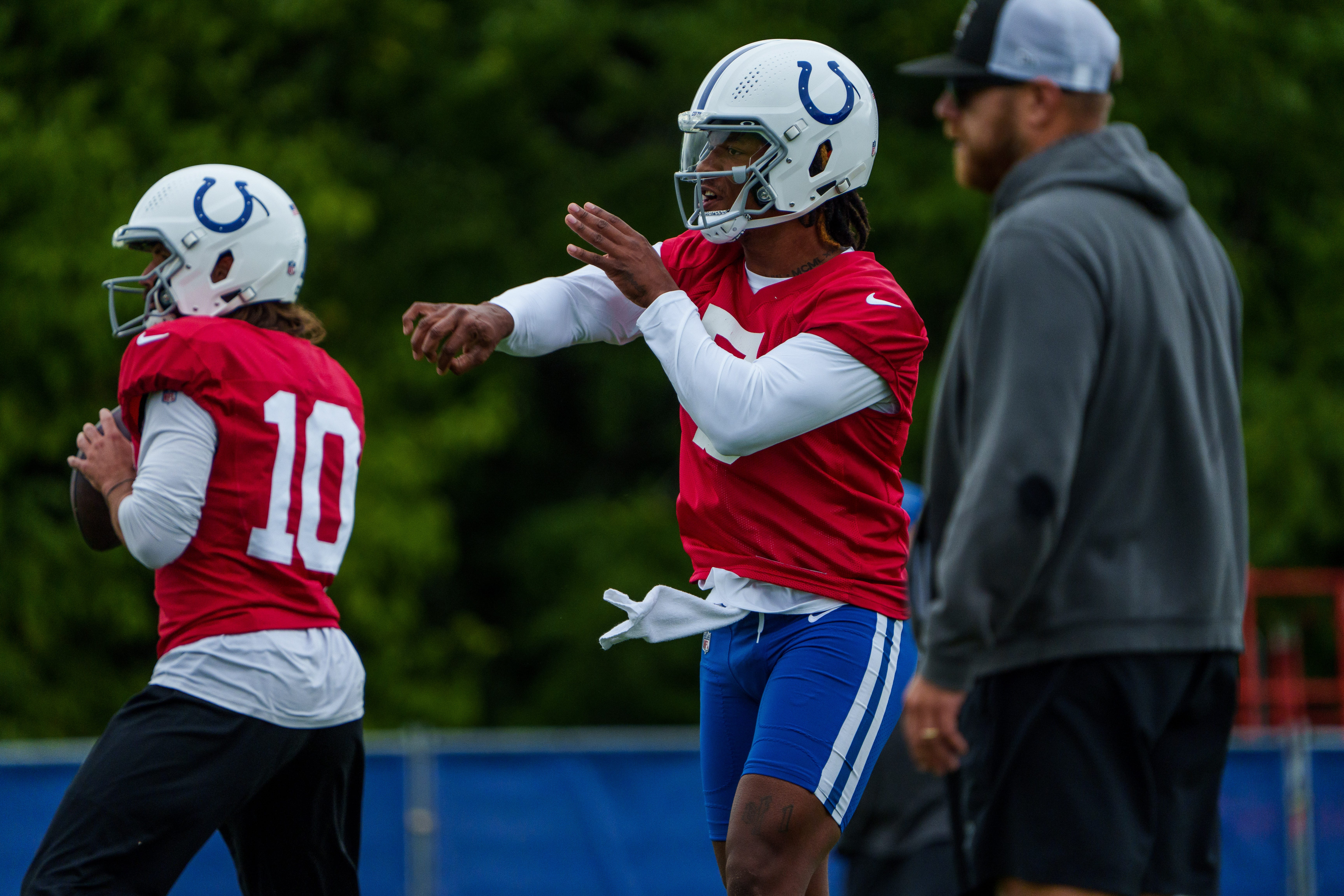 Indianapolis Colts quarterback Anthony Richardson (5) passes alongside fellow quarterback Gardner Minshew (10) on Tuesday, Aug. 15, 2023, during training camp at Grand Park Sports Campus in Westfield, Indiana.