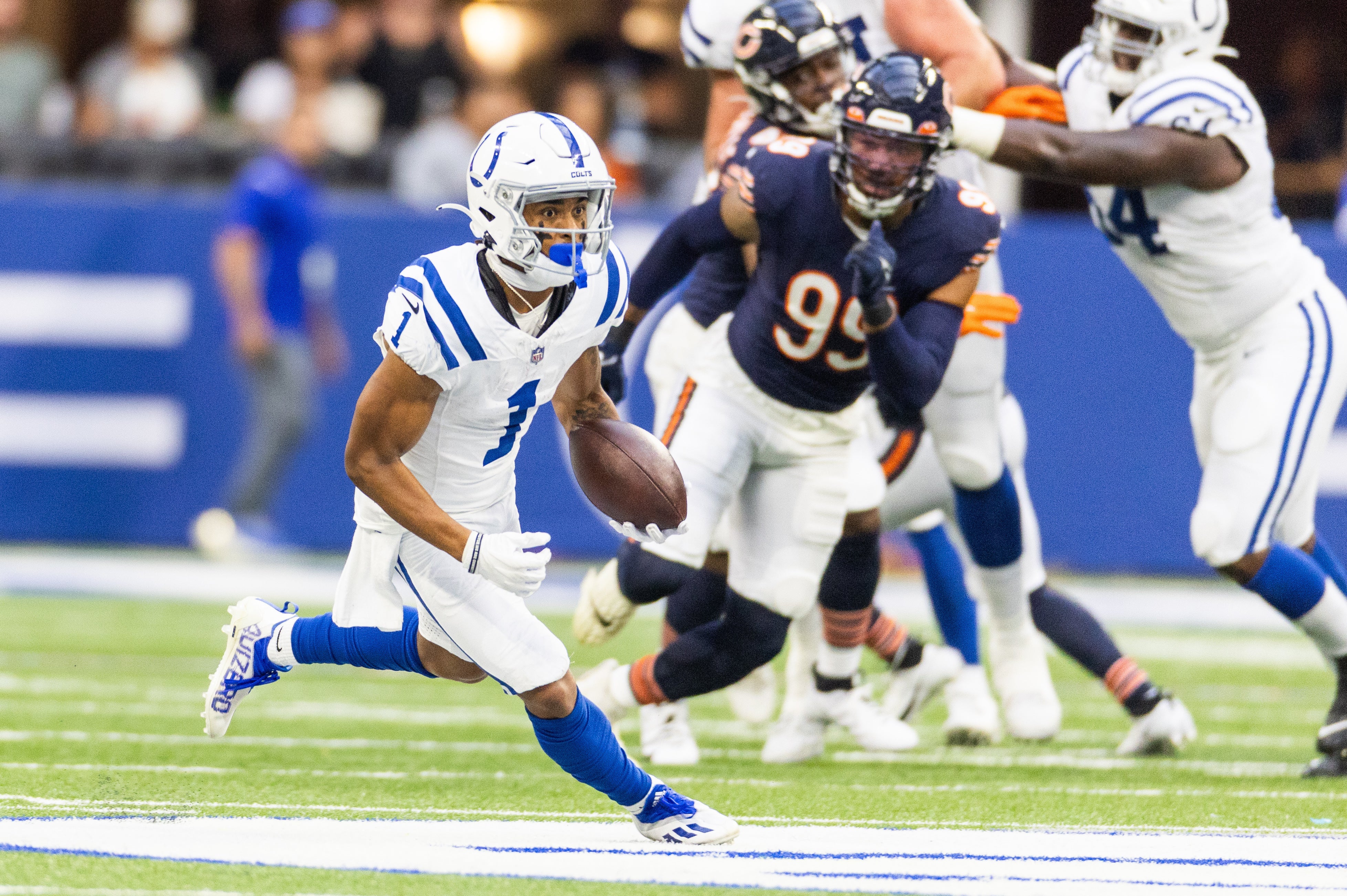 Aug 19, 2023; Indianapolis, Indiana, USA; Indianapolis Colts wide receiver Josh Downs (1) runs with the ball in the first quarter against the Chicago Bears at Lucas Oil Stadium.