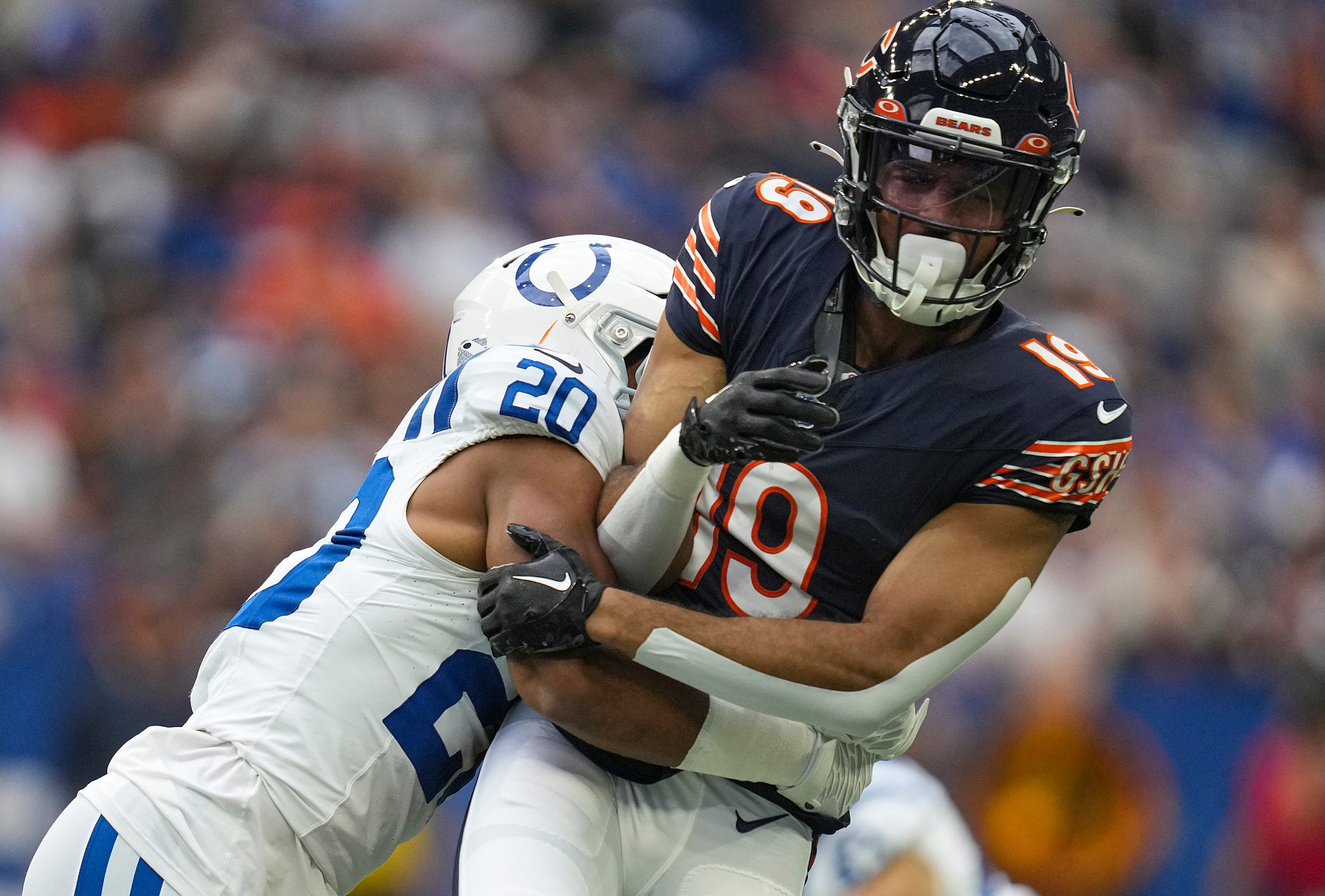 Indianapolis Colts safety Nick Cross (20) tackles Chicago Bears wide receiver Equanimeous St. Brown (19) during the first half of an NFL preseason game Saturday, Aug. 19, 2023, at Lucas Oil Stadium in Indianapolis.