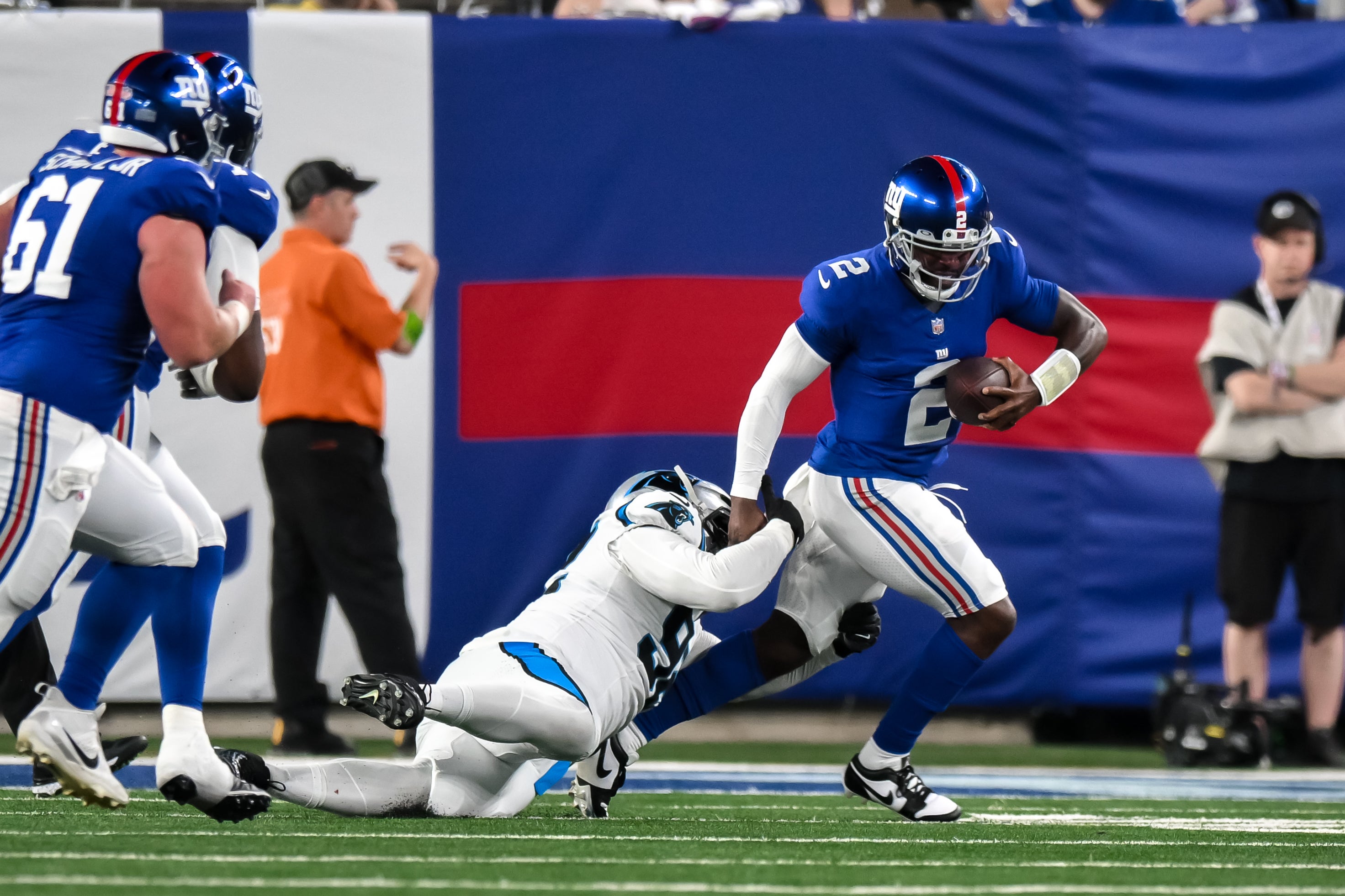 Aug 18, 2023; East Rutherford, New Jersey, USA; Carolina Panthers defensive tackle Raequan Williams (92) sacks New York Giants quarterback Tyrod Taylor (2) during the second quarter at MetLife Stadium. Mandatory Credit: John Jones-USA TODAY Sports
