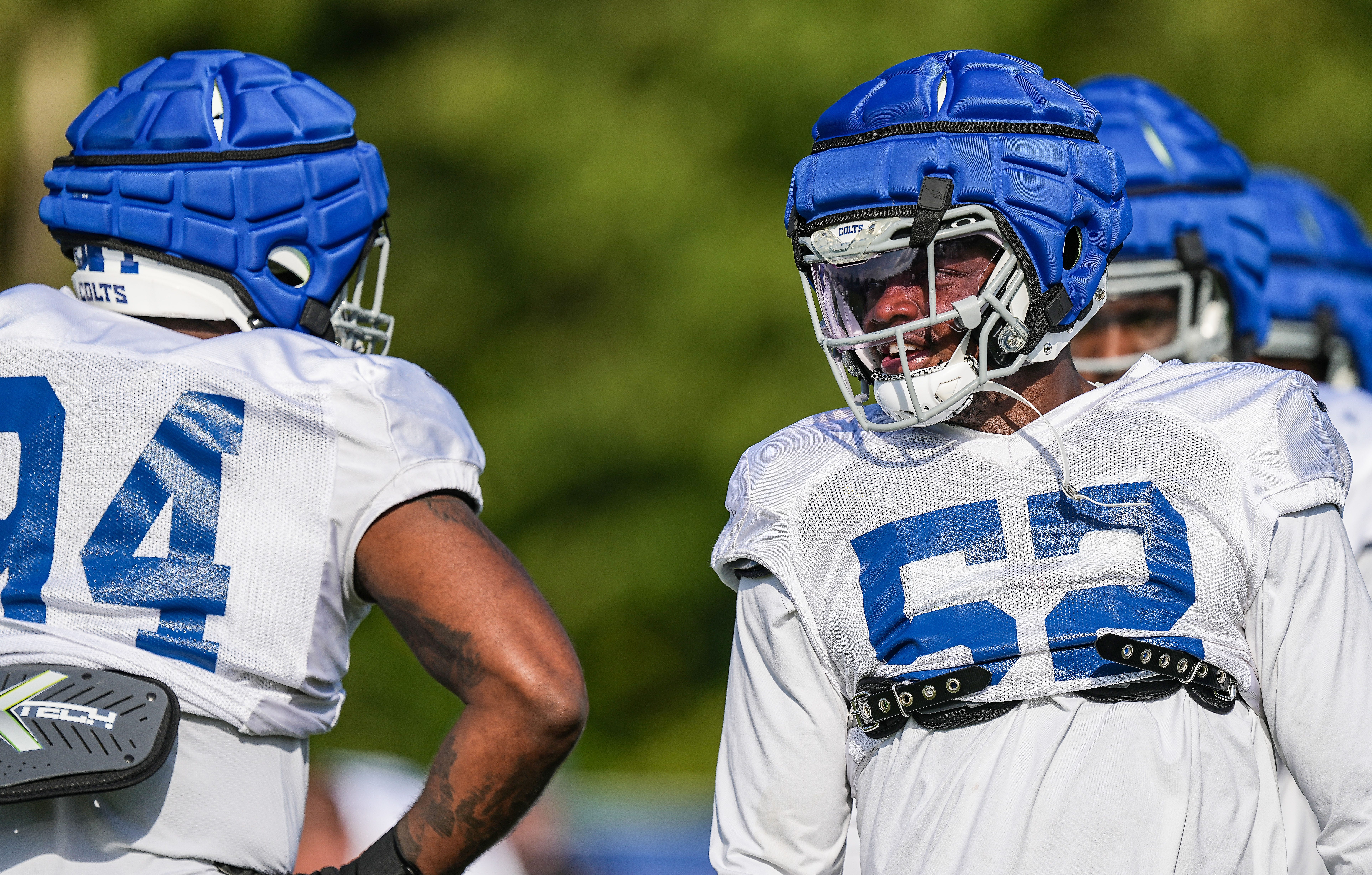 Indianapolis Colts defensive end Samson Ebukam (52) talks to Indianapolis Colts defensive end Tyquan Lewis (94) Thursday, Aug. 17, 2023, during training camp at Grand Park Sports Campus in Westfield.