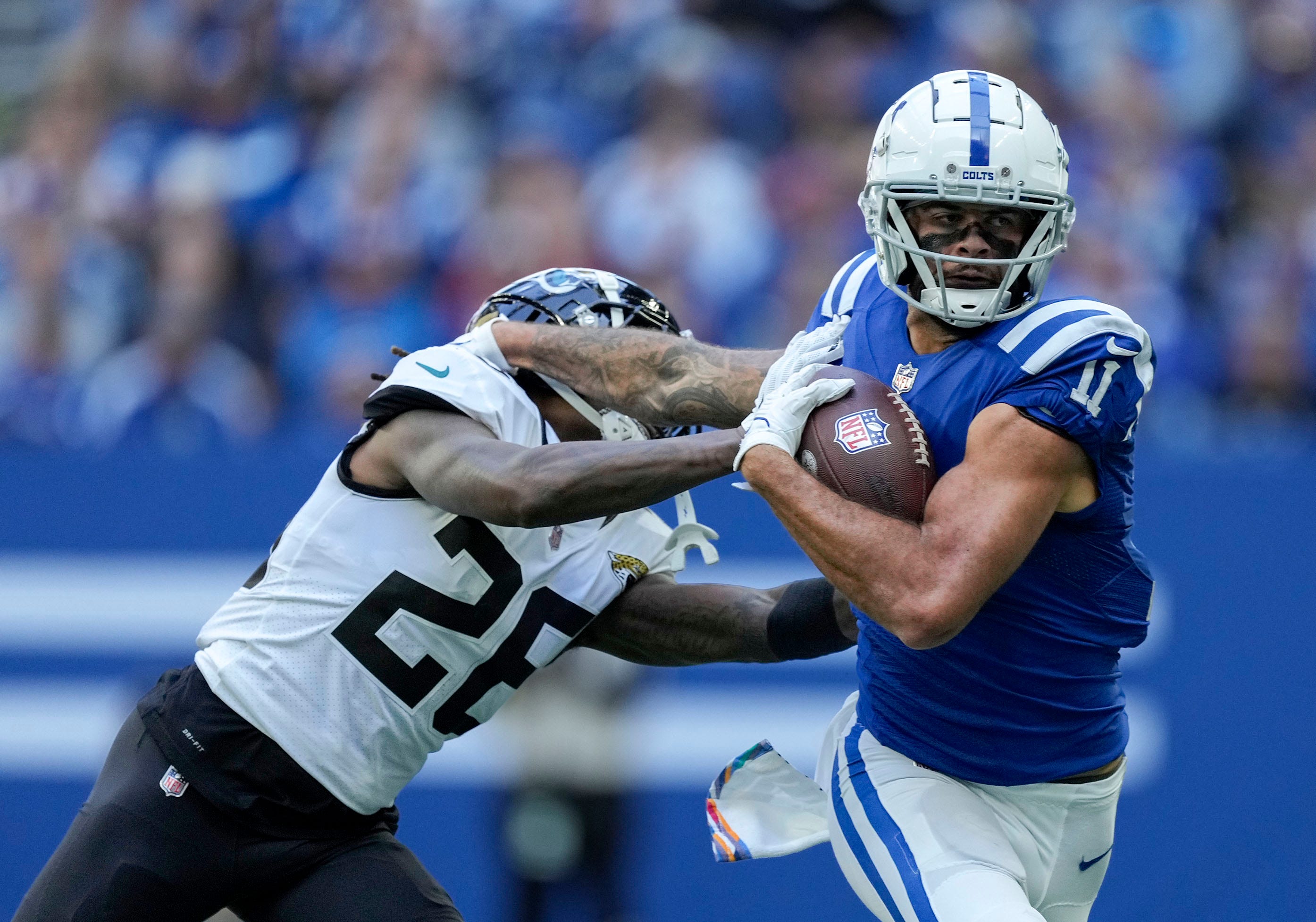 Indianapolis Colts wide receiver Michael Pittman Jr. (11) pushes off of Jacksonville Jaguars cornerback Shaquill Griffin (26) as he moves the ball downfield Sunday, Oct. 16, 2022, during a game against the Jacksonville Jaguars at Lucas Oil Stadium in Indianapolis.