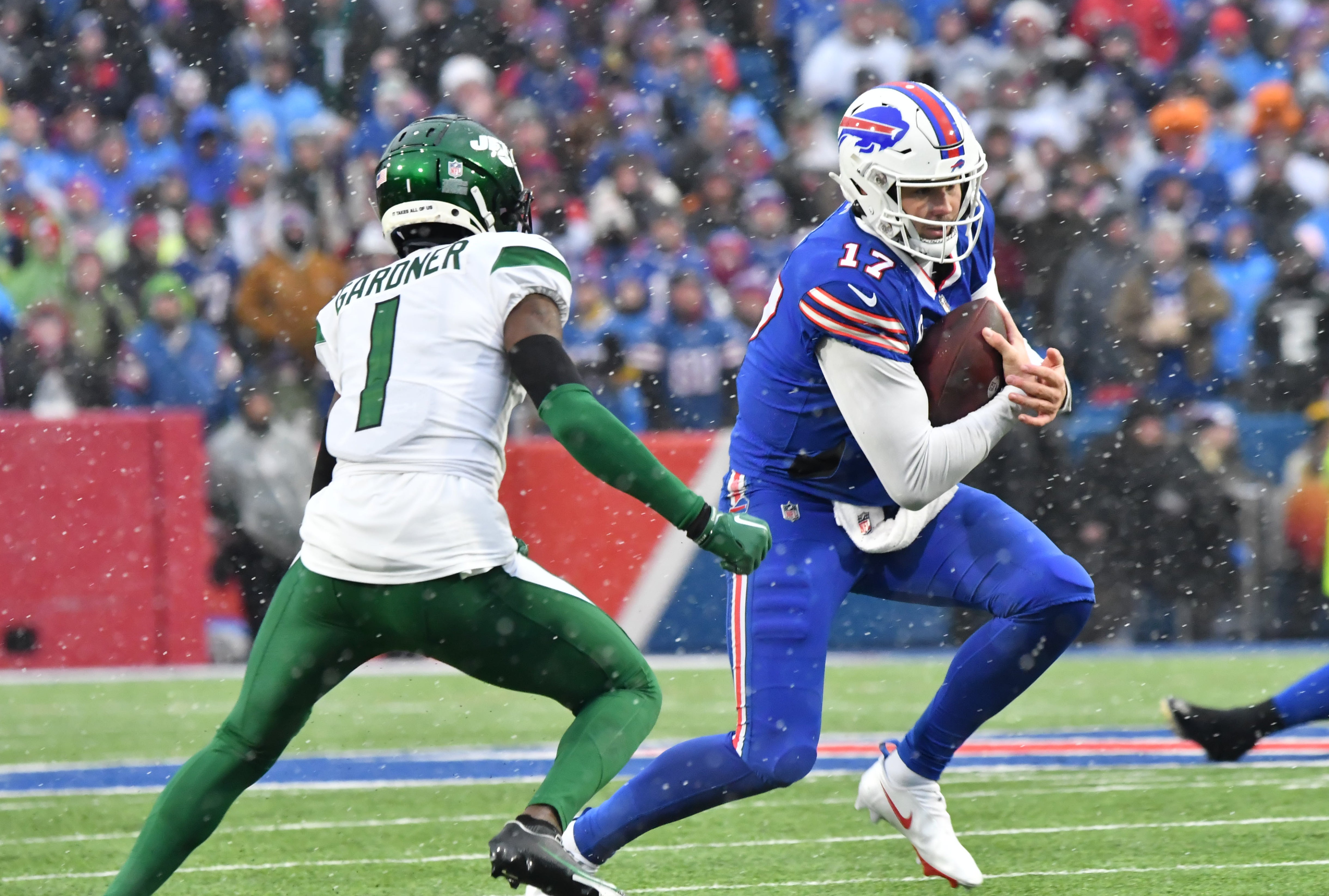 Buffalo Bills quarterback Josh Allen (17) runs the ball against New York Jets cornerback Sauce Gardner (1) in the second quarter at Highmark Stadium.