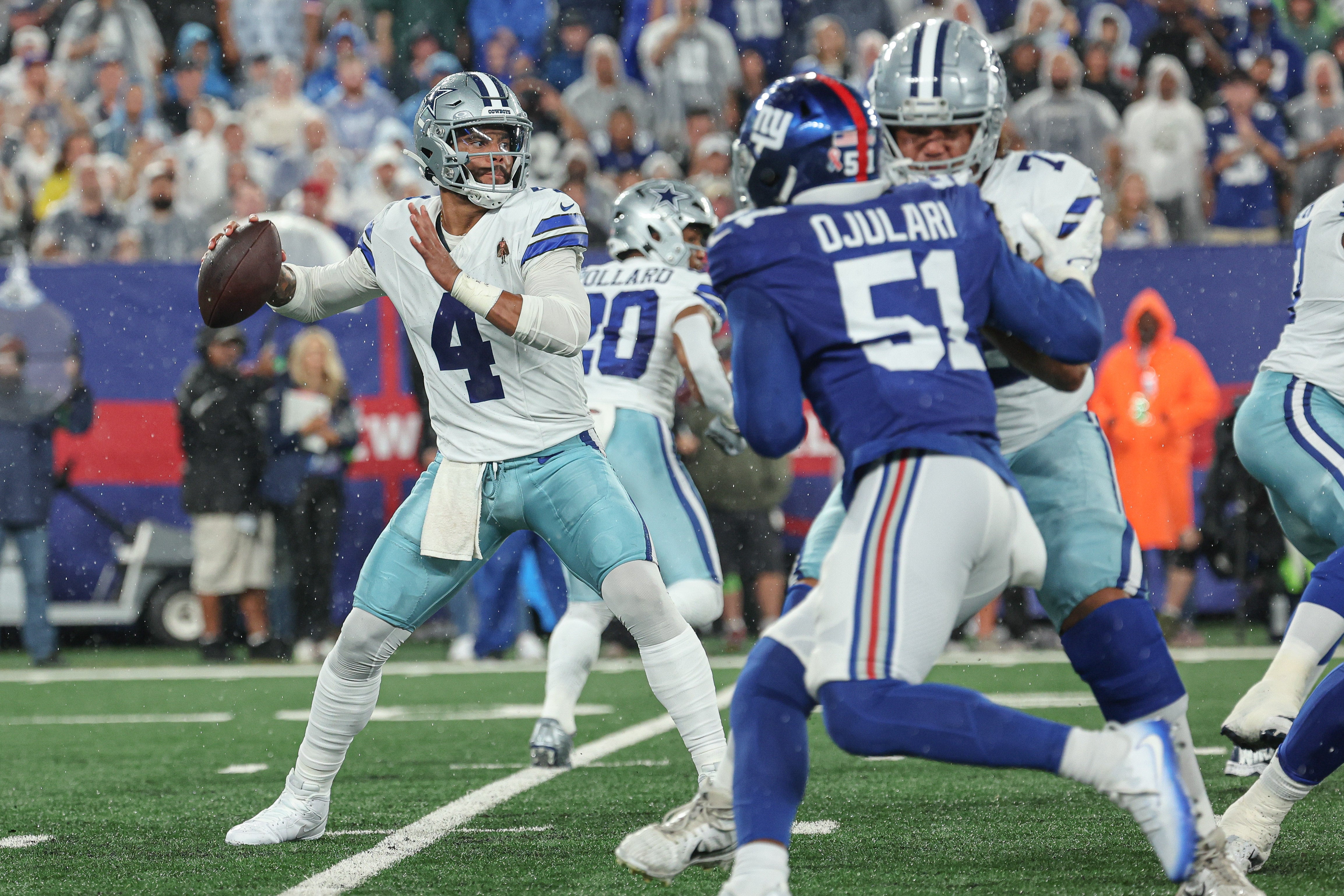 Dallas Cowboys quarterback Dak Prescott (4) throws the ball as New York Giants linebacker Azeez Ojulari (51) defends during the first quarter at MetLife Stadium. Mandatory Credit: Vincent Carchietta-USA TODAY Sports