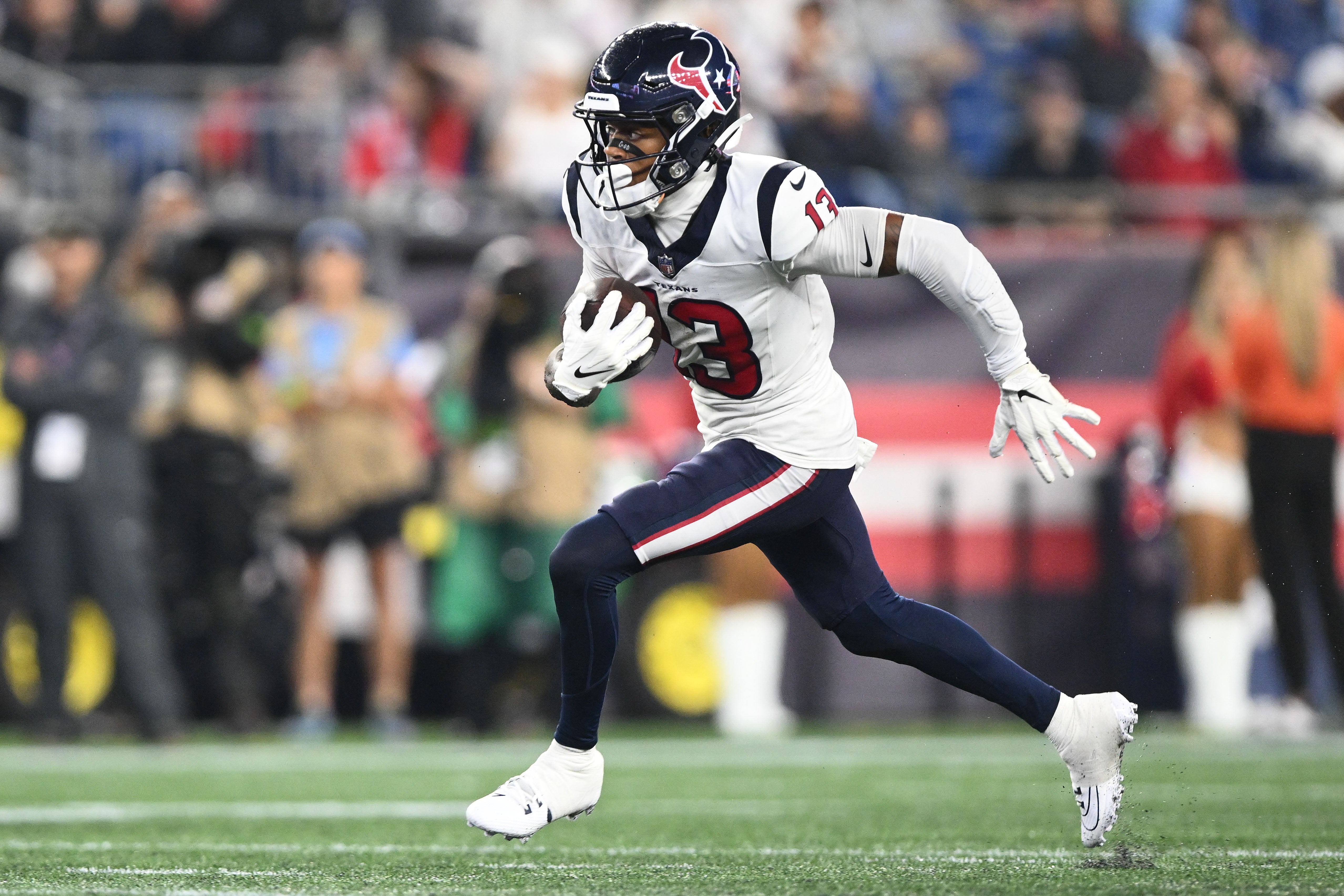 Aug 10, 2023; Foxborough, Massachusetts, USA; Houston Texans wide receiver Tank Dell (13) runs with the ball against the New England Patriots during the first half at Gillette Stadium.