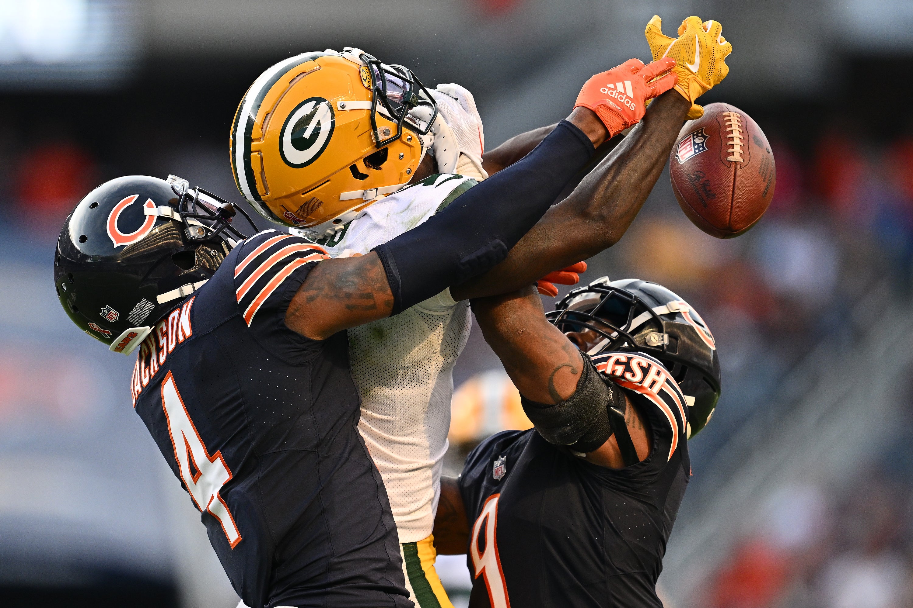 Sep 10, 2023; Chicago, Illinois, USA; Green Bay Packers wide receiver Jayden Reed (11) battles with Chicago Bears defensive back Eddie Jackson (4) and defensive back Jaquan Brisker (9) for a pass in the second half at Soldier Field. Mandatory Credit: Jamie Sabau-USA TODAY Sports  