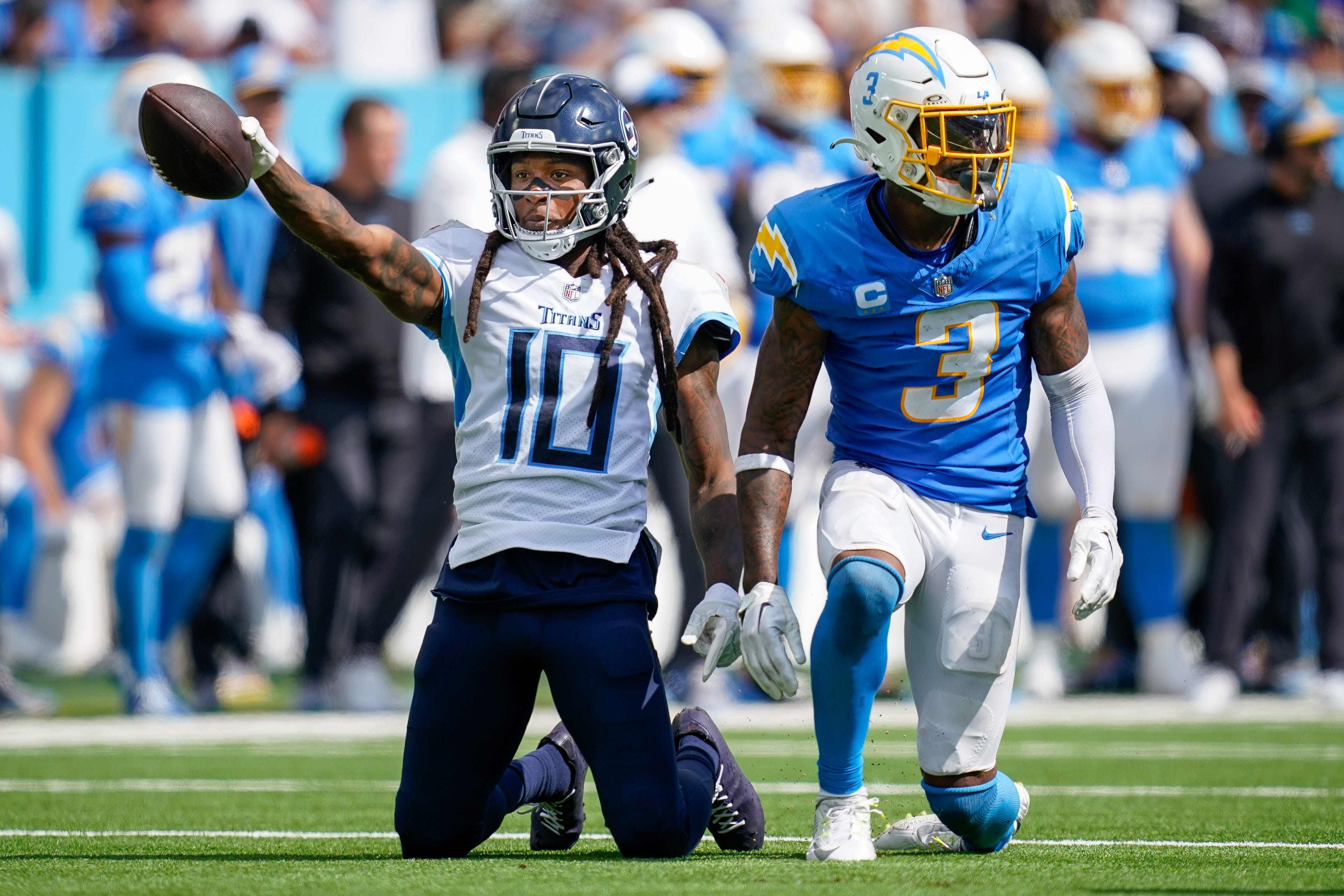 Tennessee Titans wide receiver DeAndre Hopkins (10) celebrates receiving a pass next to Los Angeles Chargers safety Derwin James Jr. (3) during the fourth quarter at Nissan Stadium in Nashville, Tenn., Sunday, Sept. 17, 2023. Andrew Nelles / The Tennessean / USA TODAY NETWORK