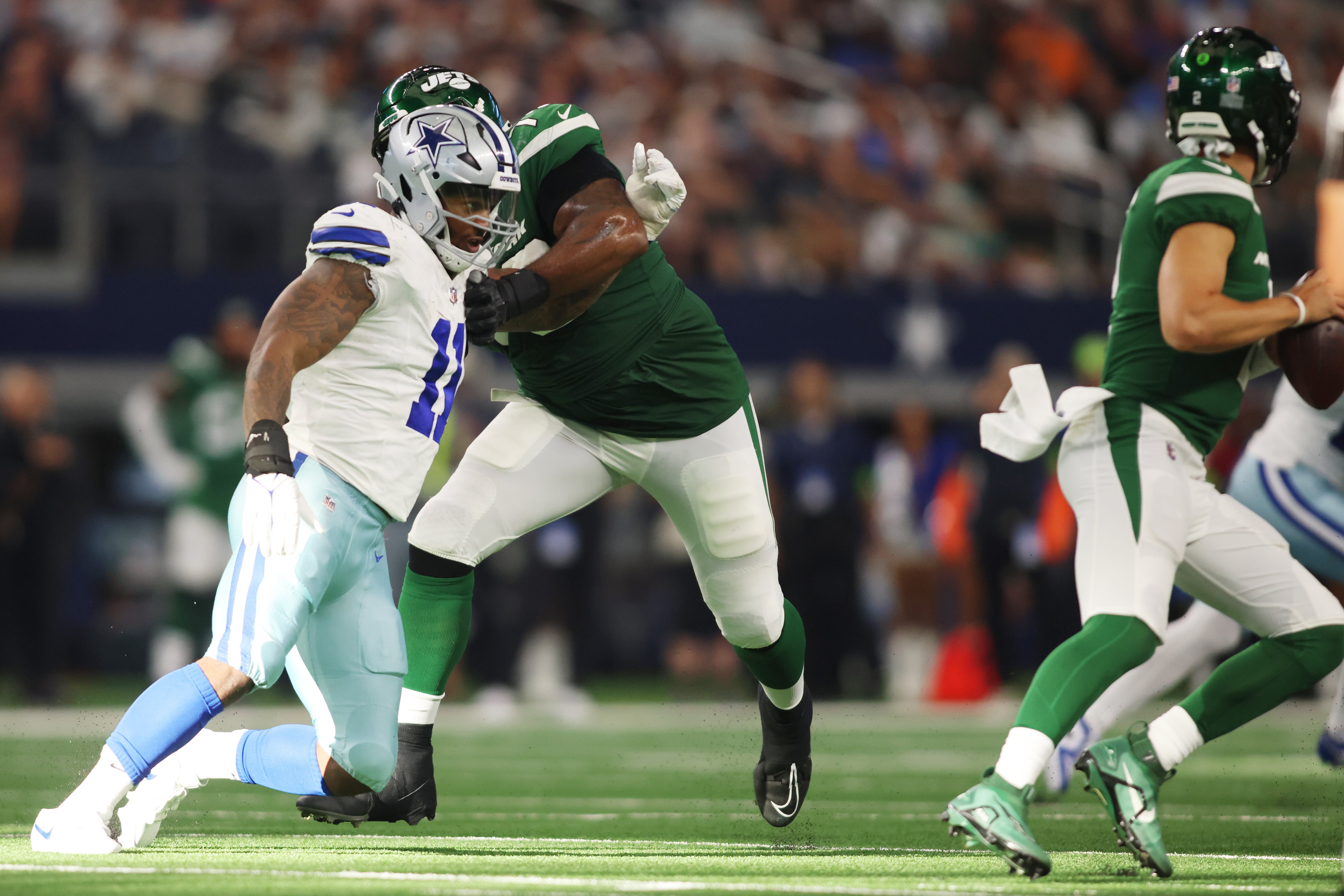 Dallas Cowboys linebacker Micah Parsons (11) rushes the quarterback against New York Jets offensive tackle Duane Brown (76) in the fourth quarter at AT&T Stadium.