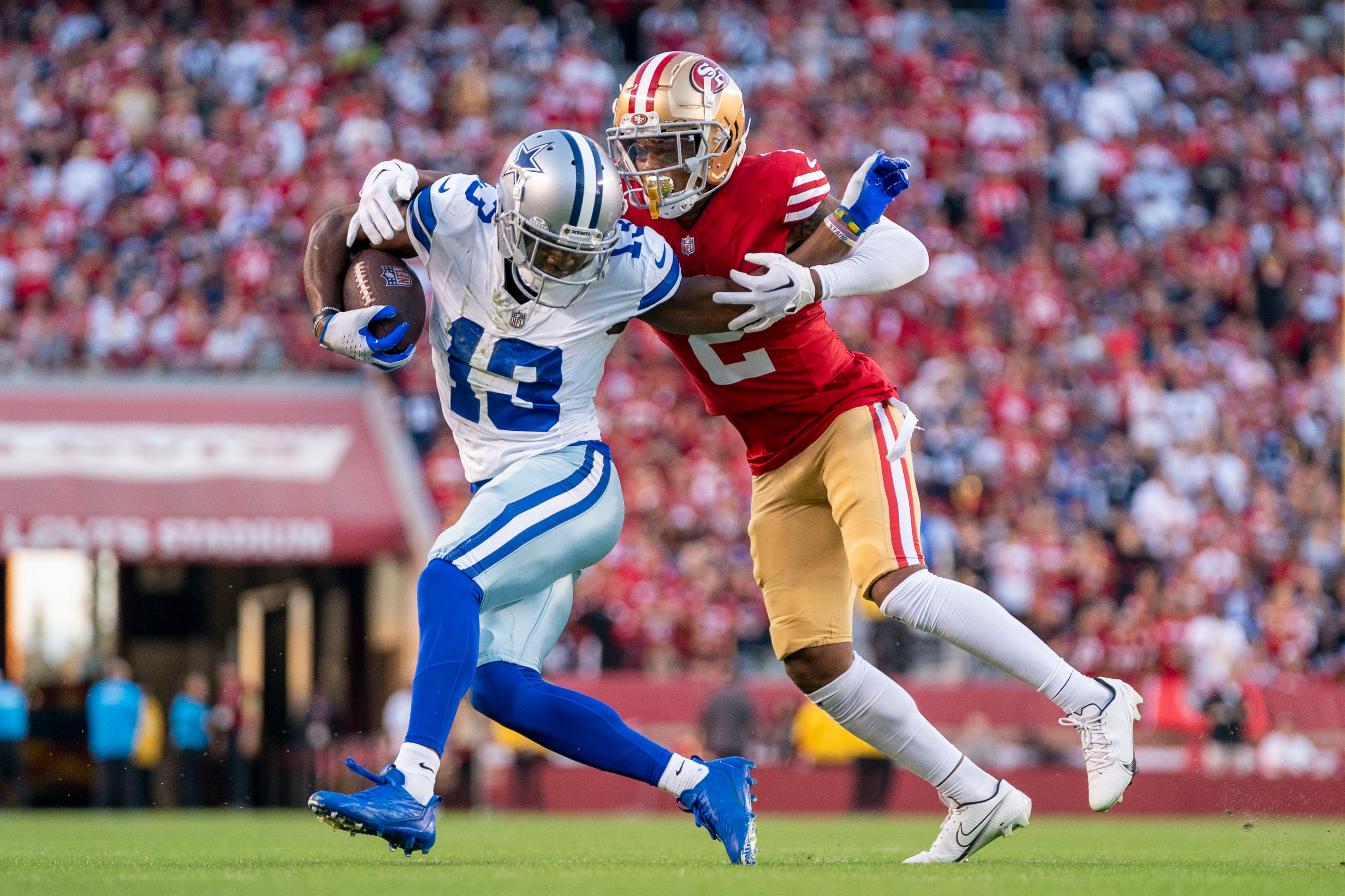 October 8, 2023; Santa Clara, California, USA; Dallas Cowboys wide receiver Michael Gallup (13) is tackled by San Francisco 49ers cornerback Deommodore Lenoir (2) during the second quarter at Levi's Stadium.
