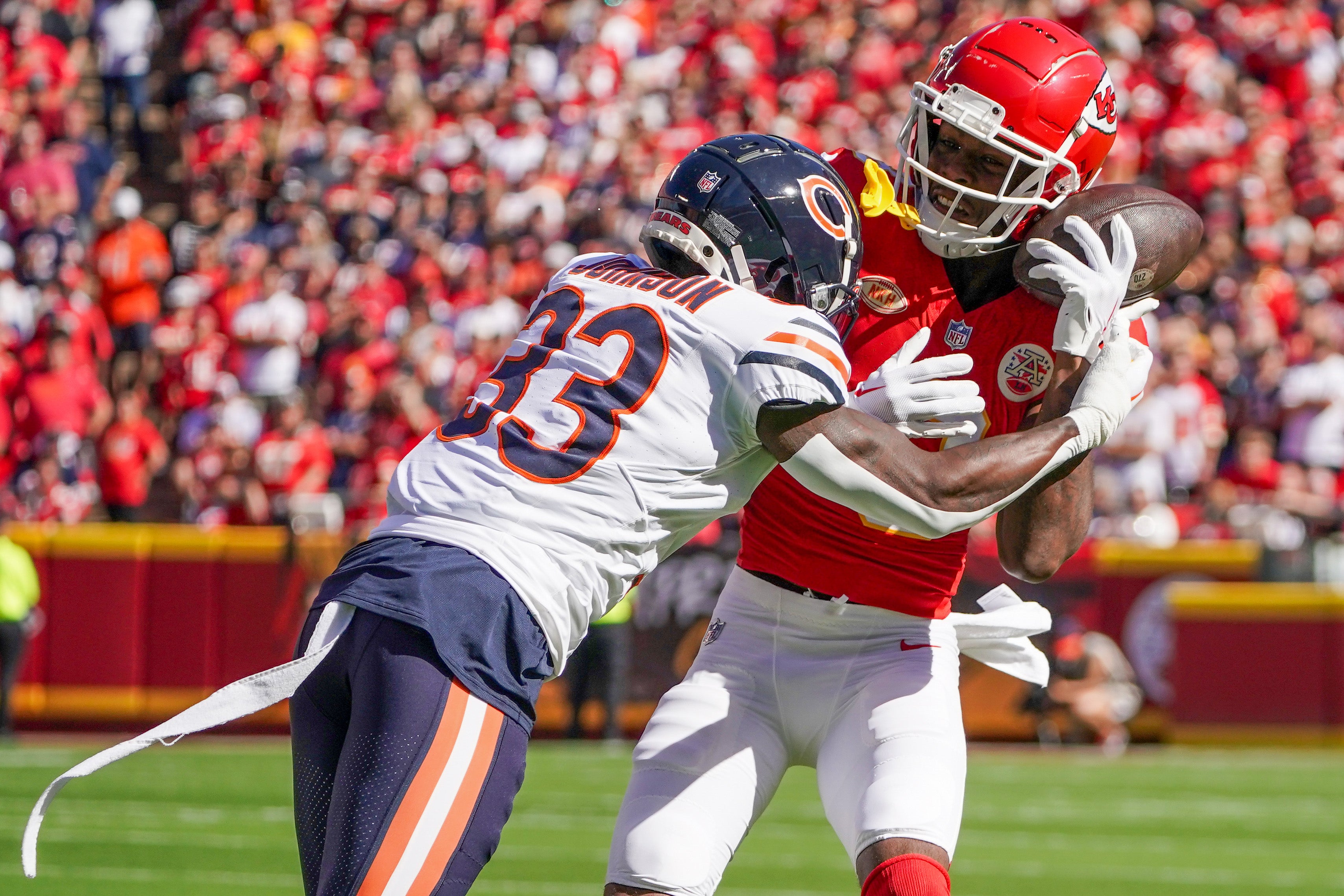 Sep 24, 2023; Kansas City, Missouri, USA; Chicago Bears cornerback Jaylon Johnson (33) breaks up a pass intended for Kansas City Chiefs wide receiver Justyn Ross (8) during the game at GEHA Field at Arrowhead Stadium.