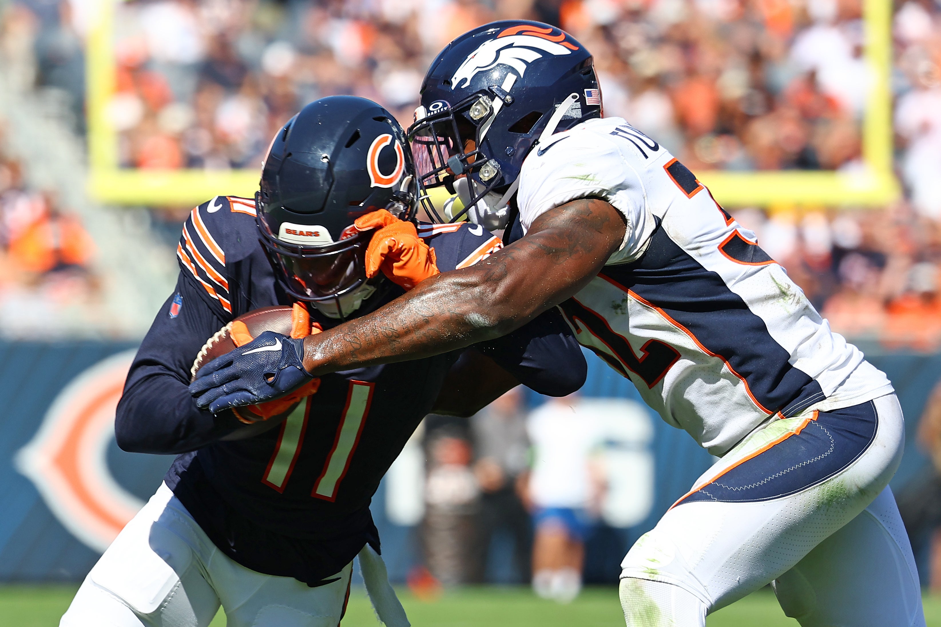 Oct 1, 2023; Chicago, Illinois, USA; Chicago Bears wide receiver Darnell Mooney (11) runs the ball after a catch against Denver Broncos safety Delarrin Turner-Yell (32) during the second half at Soldier Field.