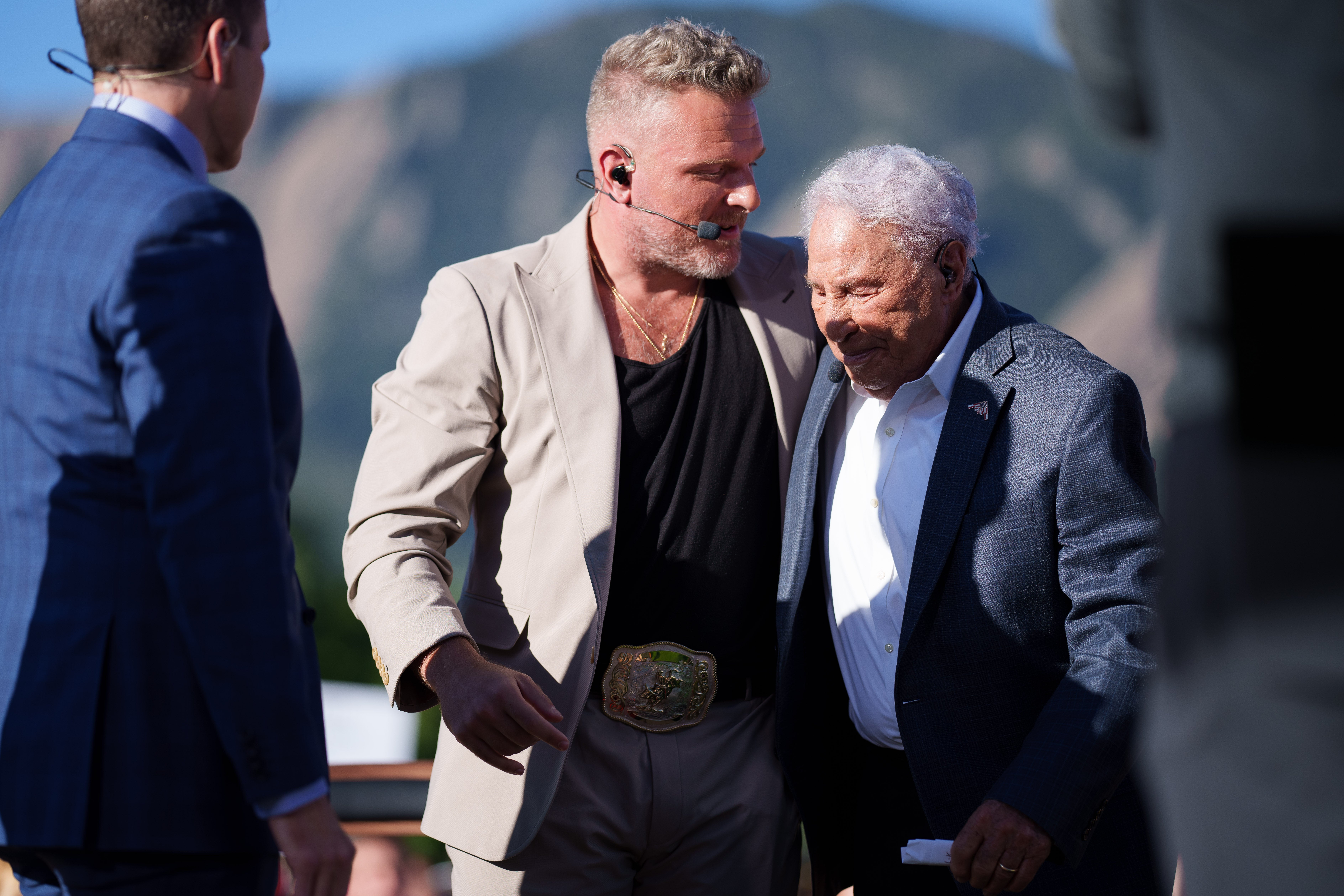 Pat McAfee hugs Lee Corso on the set of ESPN College GameDay prior to the game between the Colorado Buffaloes and the Colorado State Rams at Folsom Field.