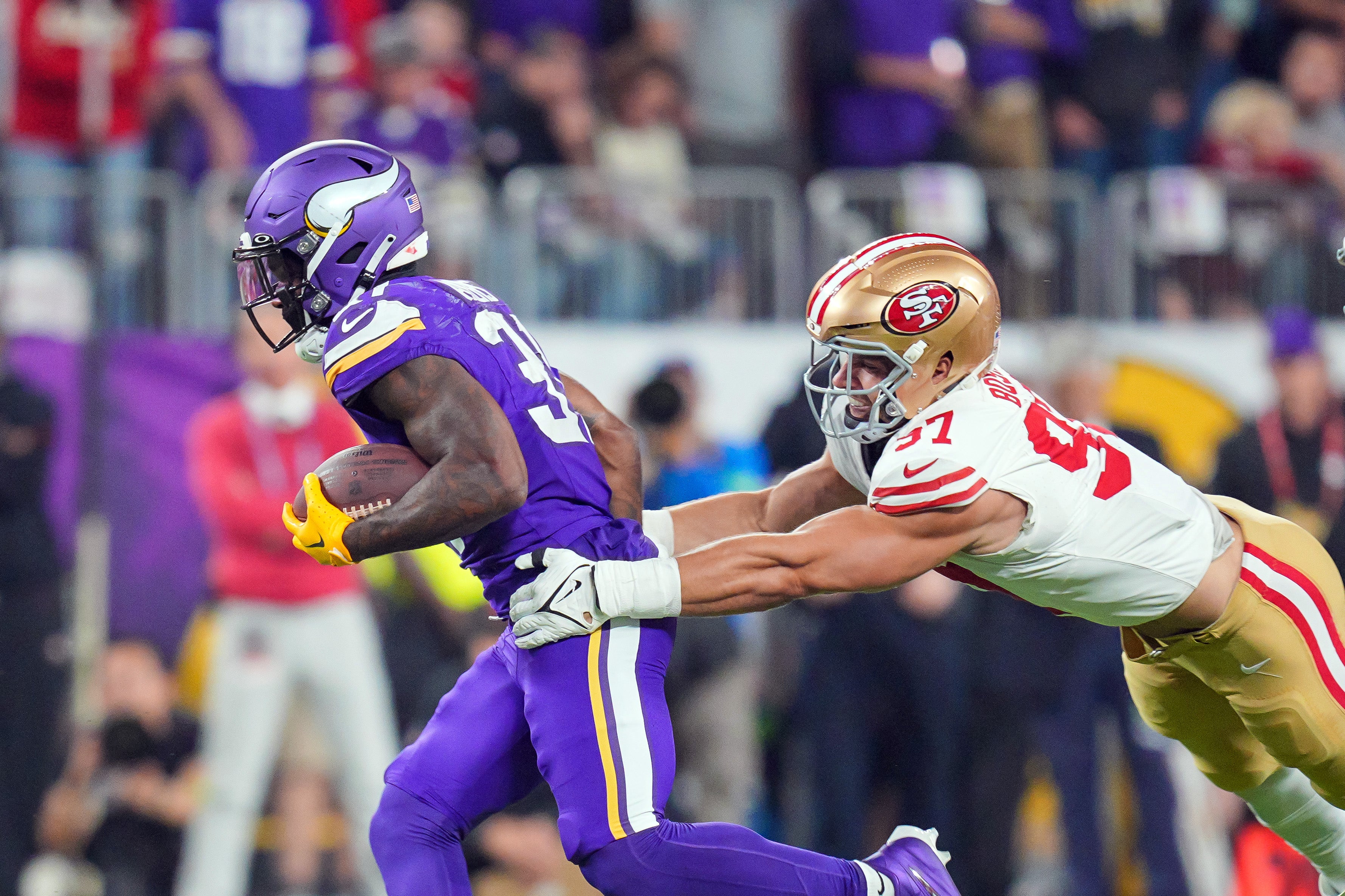 Oct 23, 2023; Minneapolis, Minnesota, USA; Minnesota Vikings running back Cam Akers (31) runs with the ball against the San Francisco 49ers defensive end Nick Bosa (97) in the second quarter at U.S. Bank Stadium.