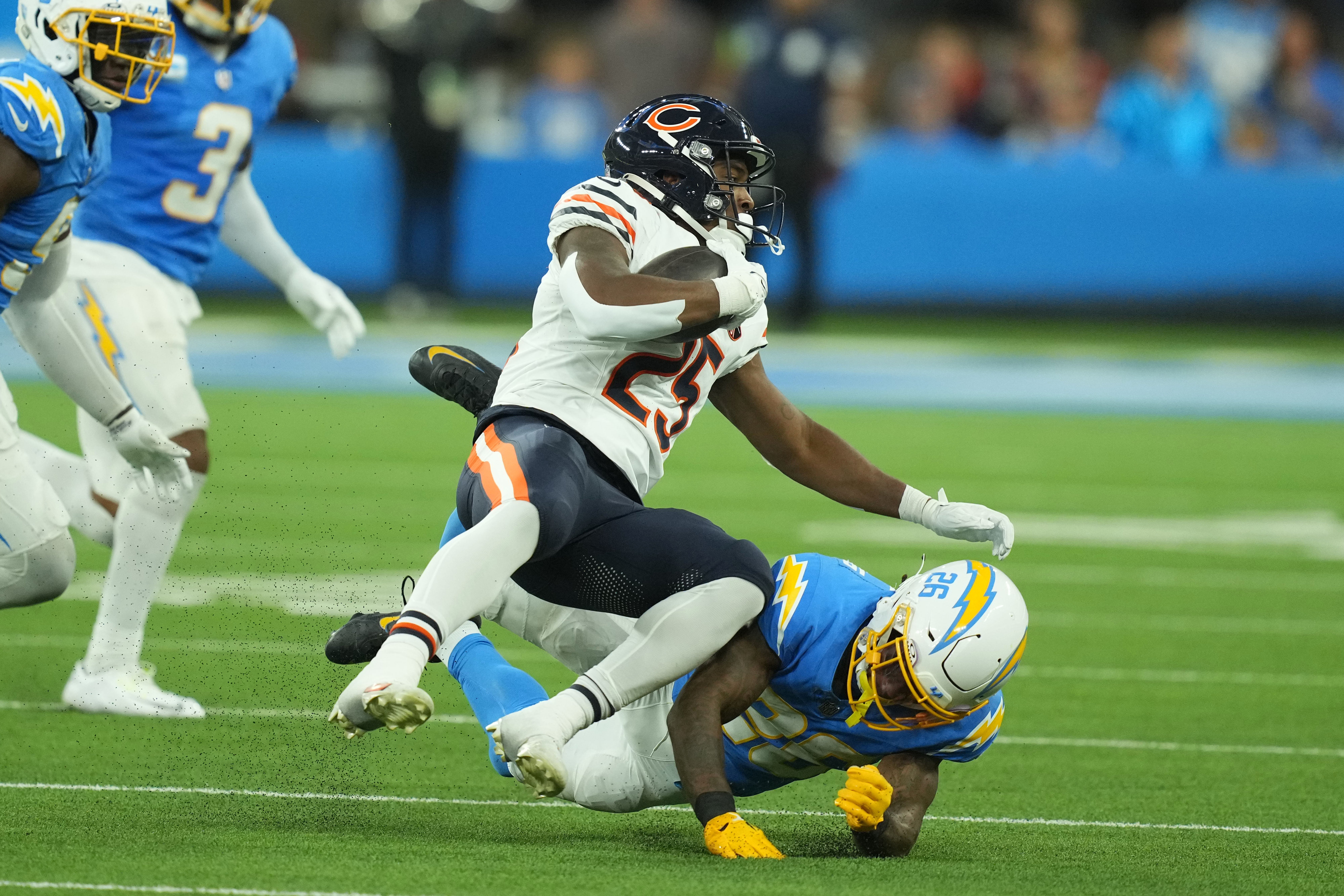 Oct 29, 2023; Inglewood, California, USA; Chicago Bears running back Darrynton Evans (25) is tackled by Los Angeles Chargers cornerback Asante Samuel Jr. (26) in the second half at SoFi Stadium.