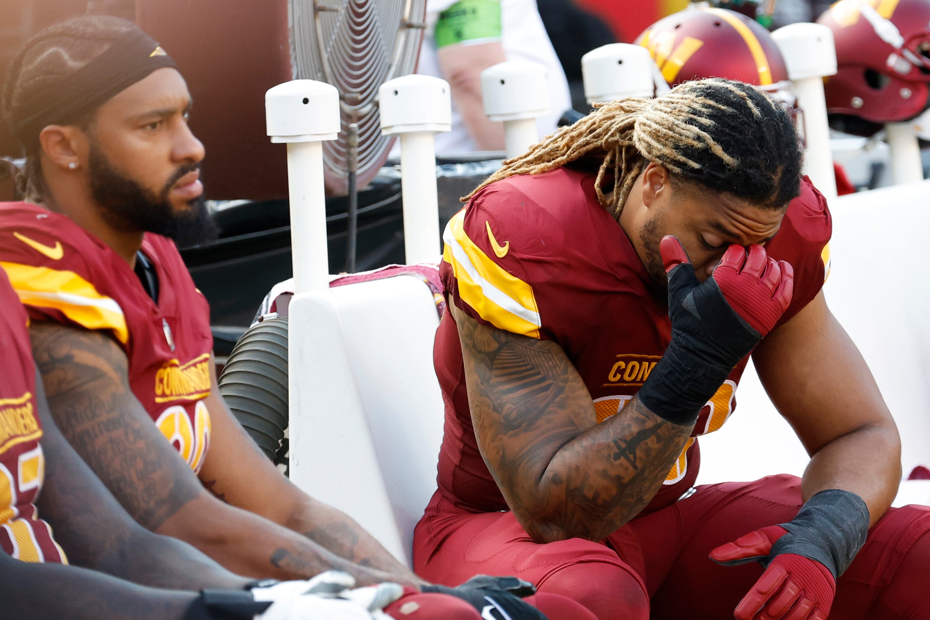 Oct 29, 2023; Landover, Maryland, USA; Washington Commanders defensive end Chase Young (99) and Commanders defensive end Montez Sweat (90) sit on the bench against the Philadelphia Eagles during the fourth quarter at FedExField.