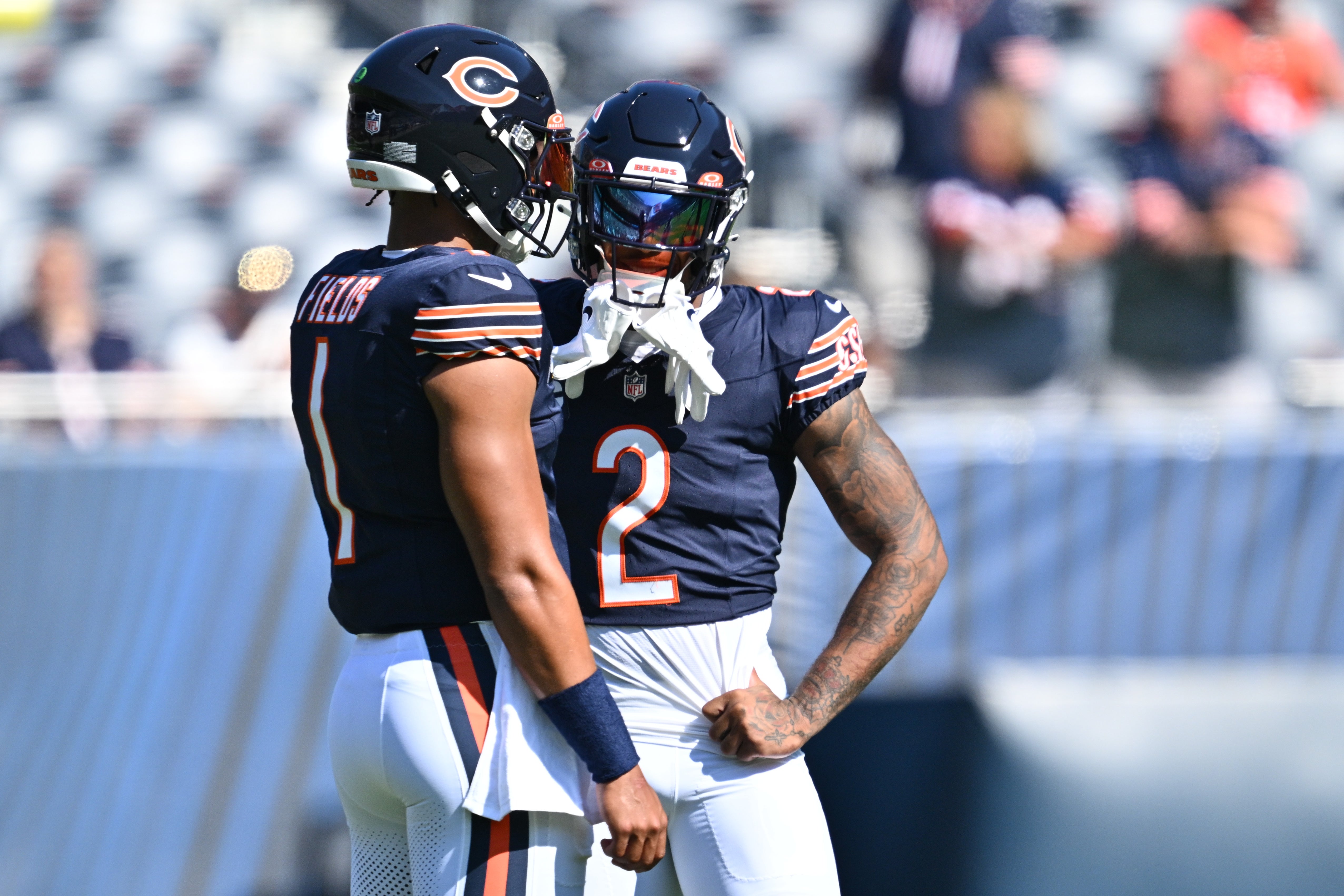 Oct 1, 2023; Chicago, Illinois, USA; Chicago Bears wide receiver DJ Moore (2) talks with quarterback Justin Fields (1) before a game against the Denver Broncos at Soldier Field.