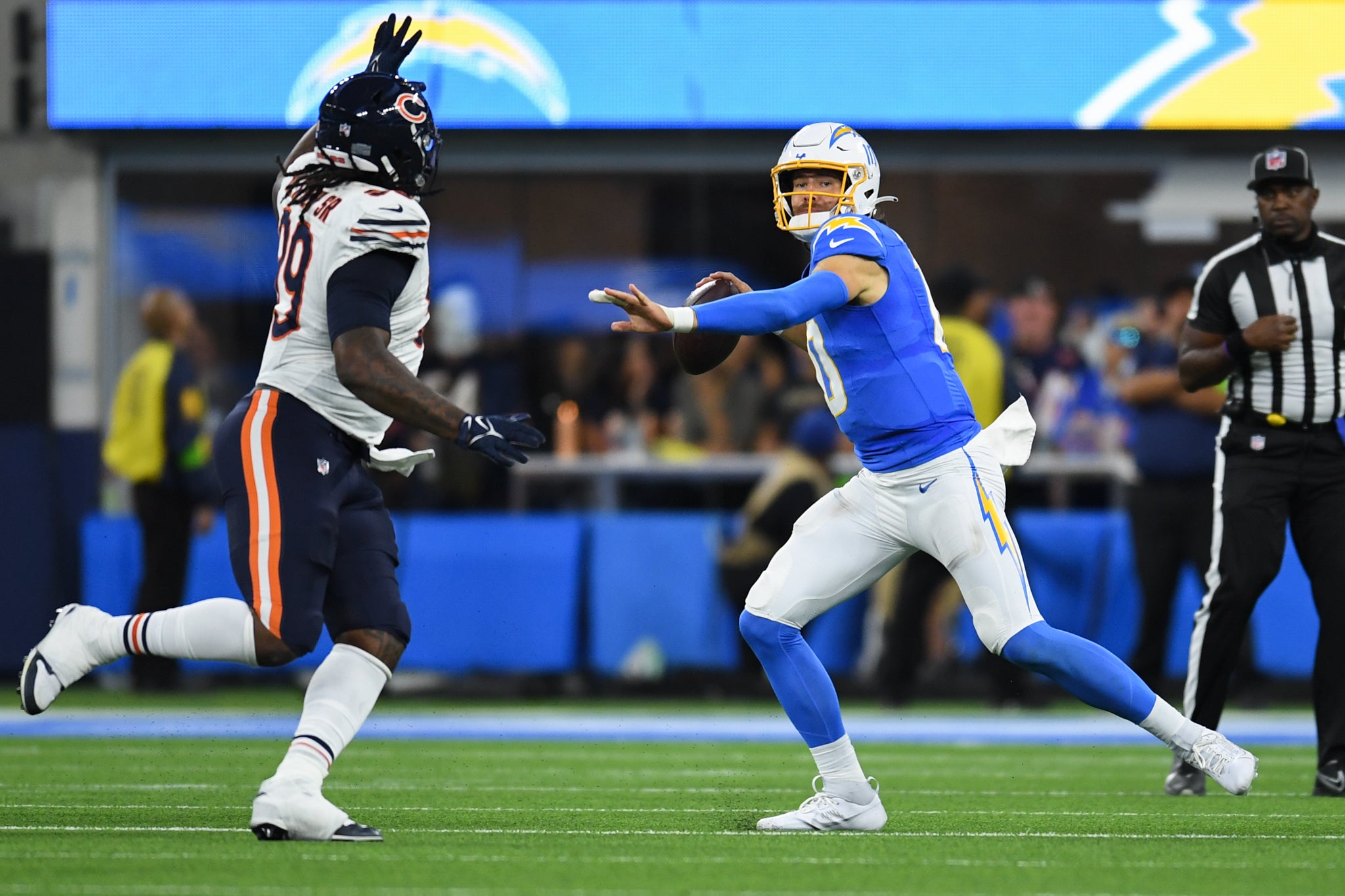 Oct 29, 2023; Inglewood, California, USA; Los Angeles Chargers quarterback Justin Herbert (10) looks to throws a pass against Chicago Bears defensive tackle Gervon Dexter Sr (99) during third quarter at SoFi Stadium.