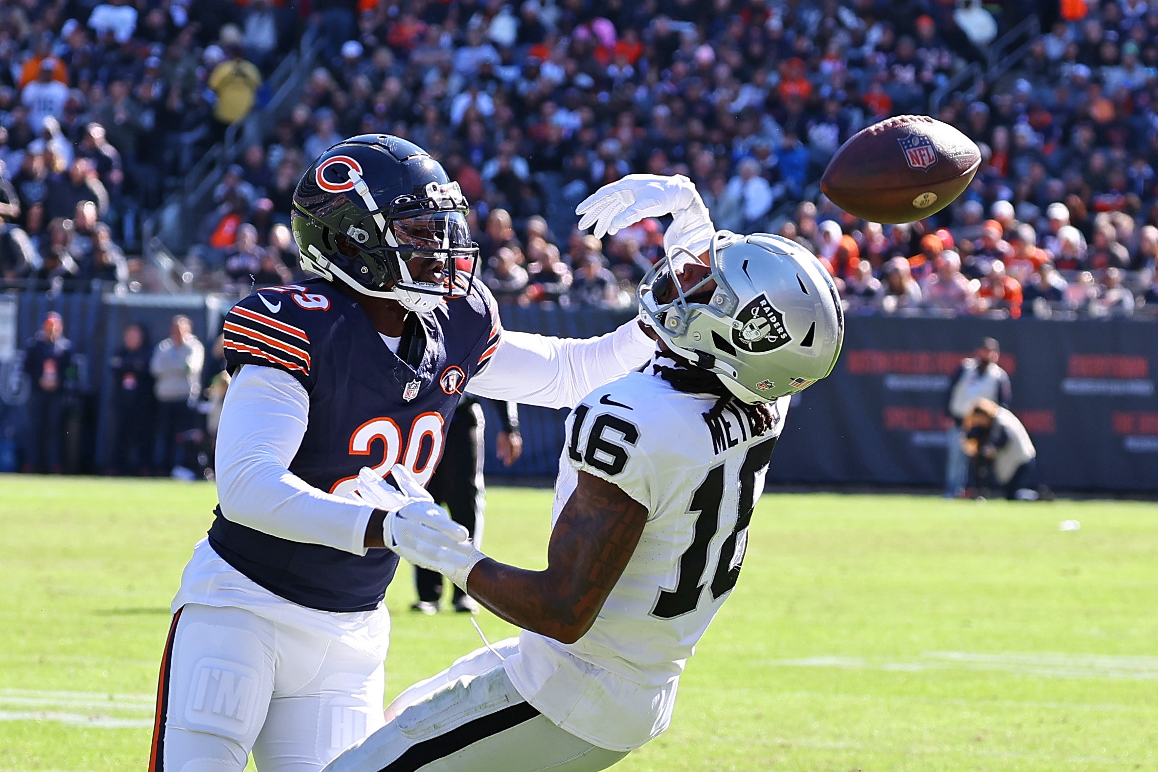 Oct 22, 2023; Chicago, Illinois, USA; Las Vegas Raiders wide receiver Jakobi Meyers (16) attempts to make a catch against Chicago Bears cornerback Tyrique Stevenson (29) in the second quarter at Soldier Field.