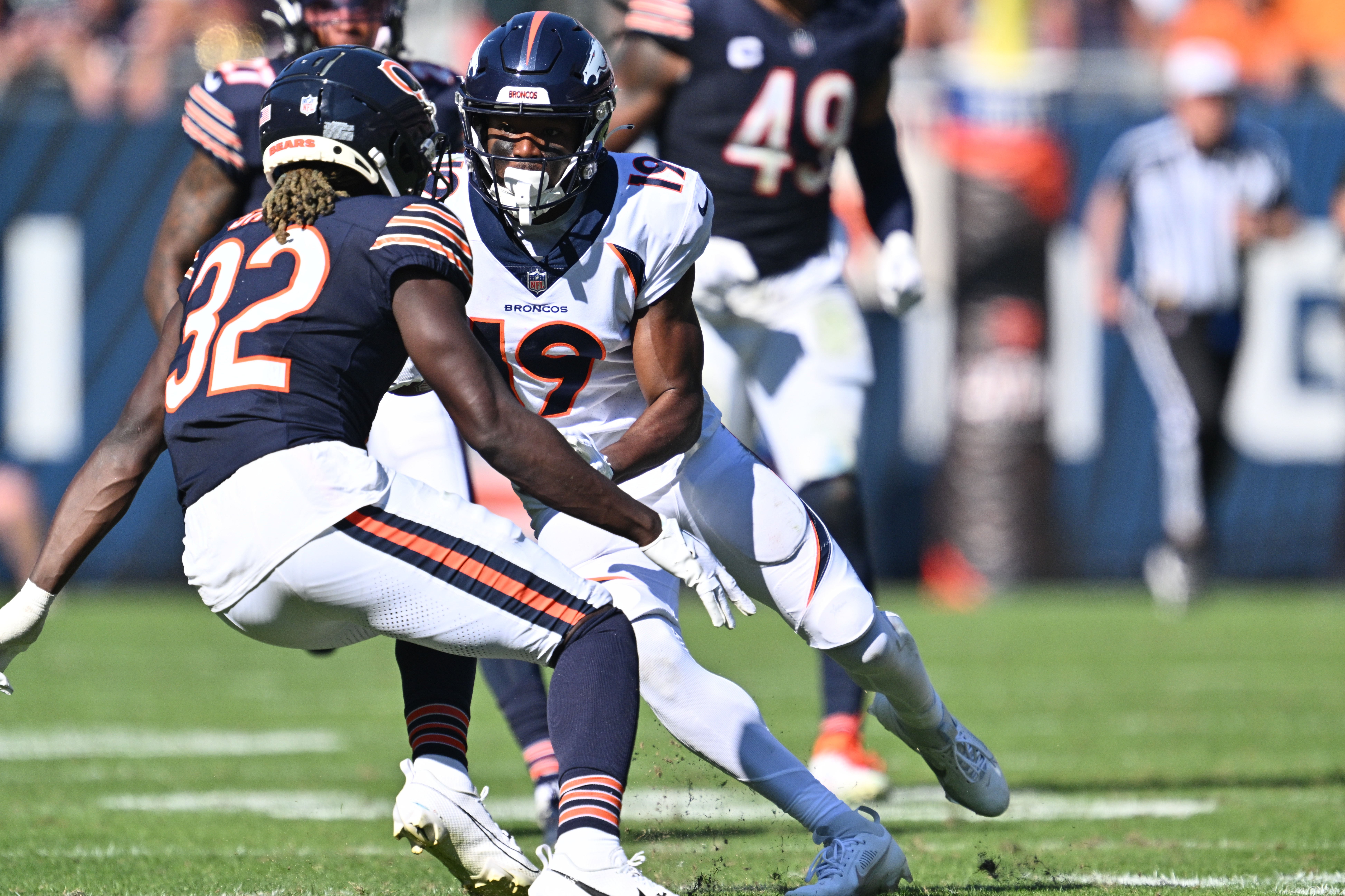 Oct 1, 2023; Chicago, Illinois, USA; Denver Broncos wide receiver Marvin Mims Jr. (19) picks up a first down on a pass reception as Chicago Bears defensive back Terell Smith (32) moves in for the tackle in the fourth quarter at Soldier Field.