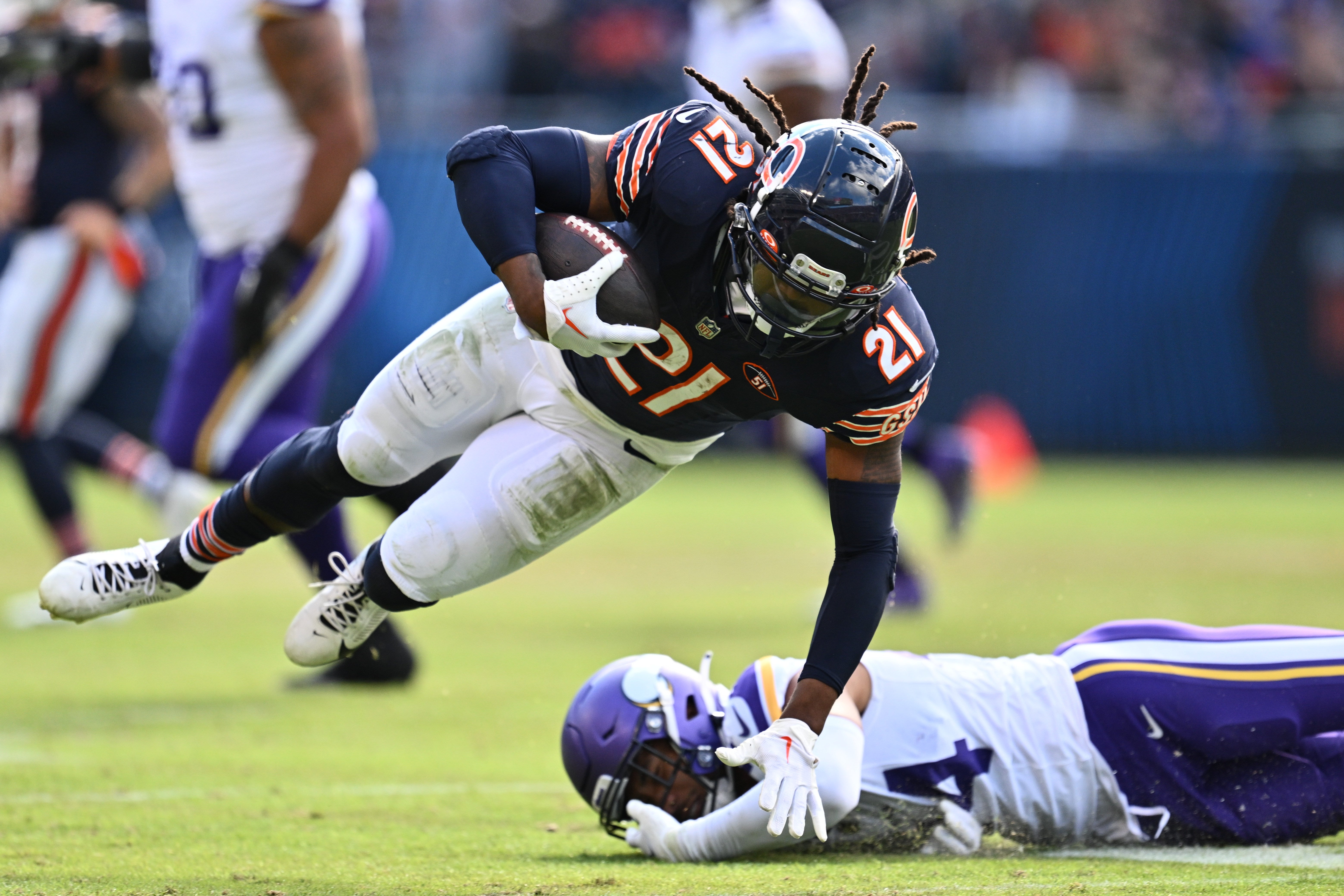 Oct 15, 2023; Chicago, Illinois, USA; Chicago Bears running back D'Onta Foreman (21) is tripped up by Minnesota Vikings safety Camryn Bynum (24) in the second half at Soldier Field.