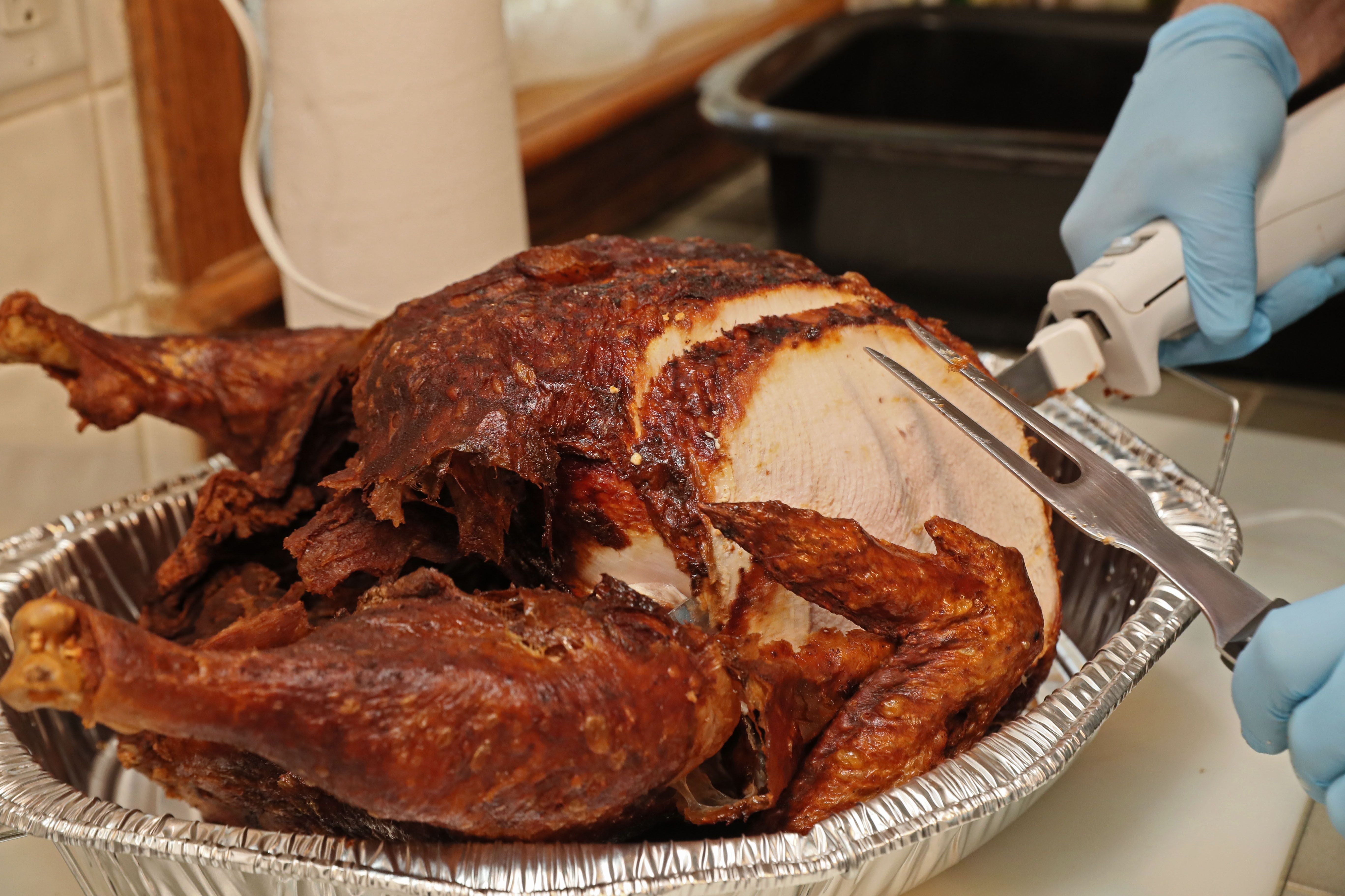 The deep-fried turkeys are golden and crispy on the outside, moist on the inside. turkeyfry14-turkey being carved  