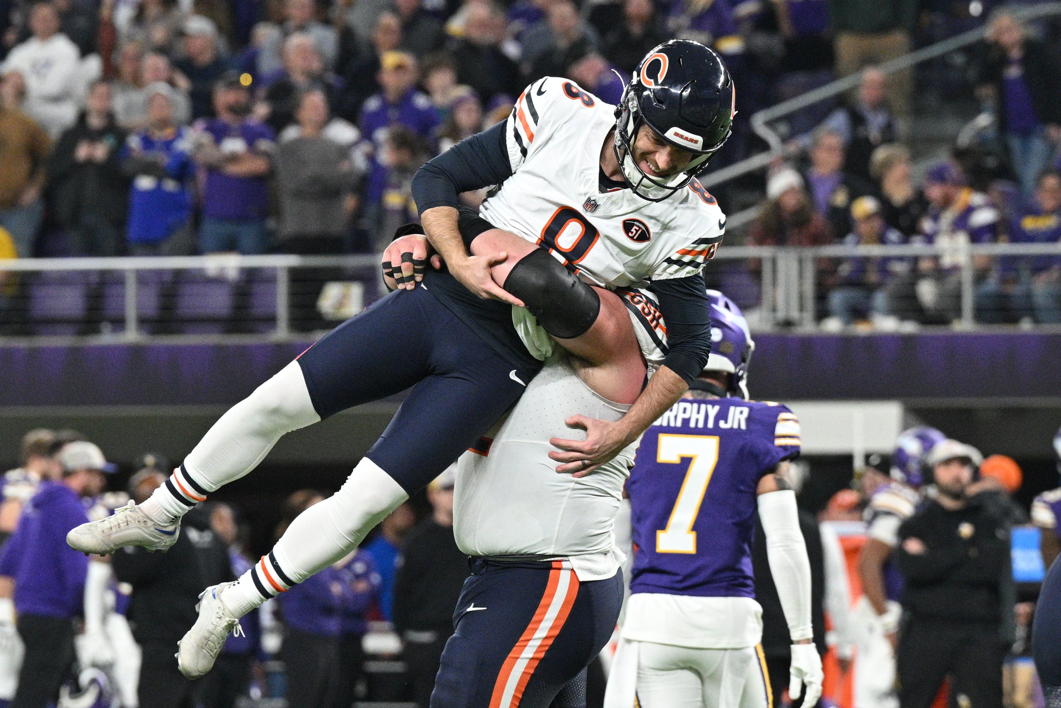 Nov 27, 2023; Minneapolis, Minnesota, USA; Chicago Bears place kicker Cairo Santos (8) reacts with guard Lucas Patrick (62) after Santos kicked a game winning field against the Minnesota Vikings during the fourth quarter at U.S. Bank Stadium.
