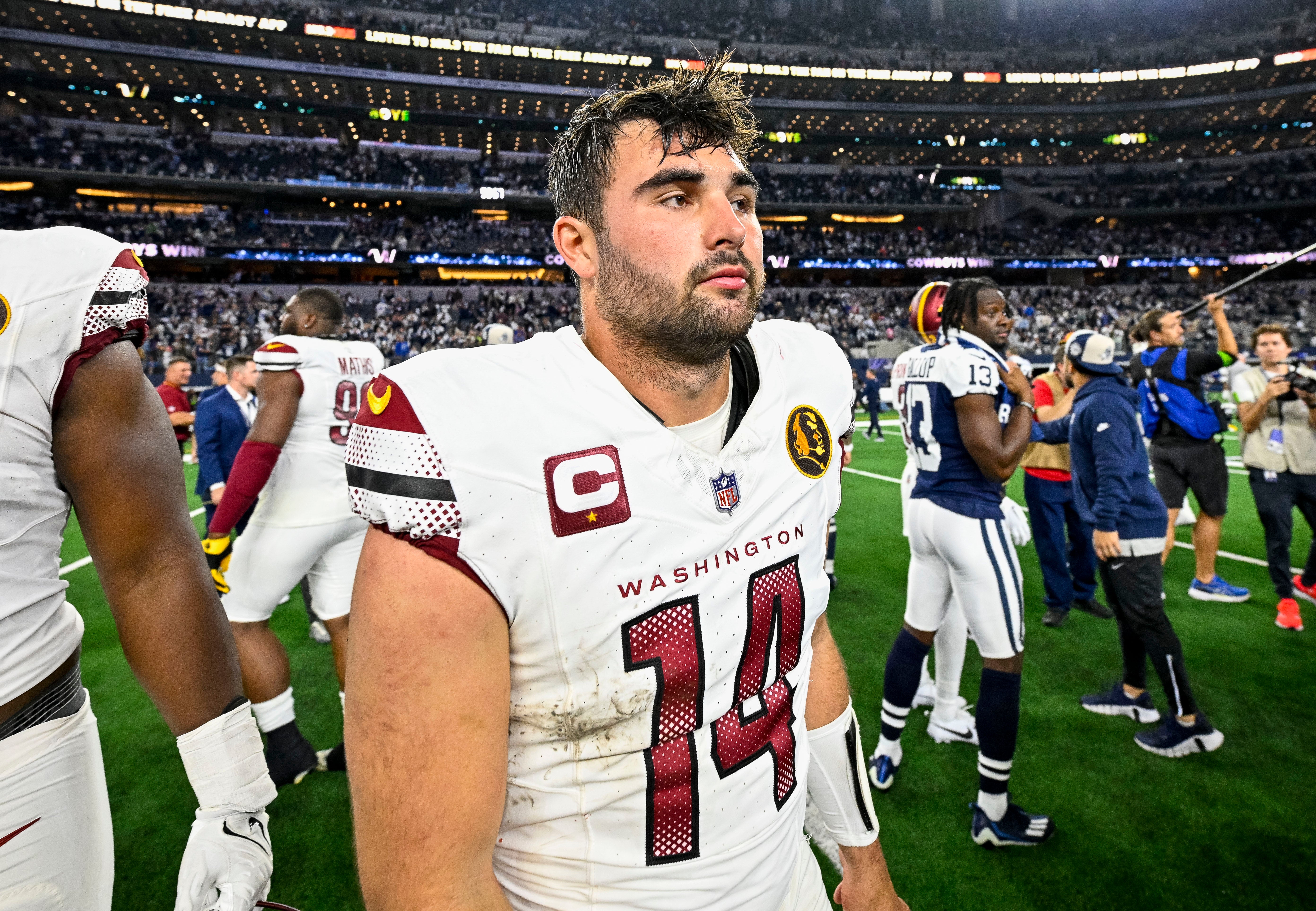 Nov 23, 2023; Arlington, Texas, USA; Washington Commanders quarterback Sam Howell (14) walks off the field after the Commanders loss to the Dallas Cowboys at AT&T Stadium.