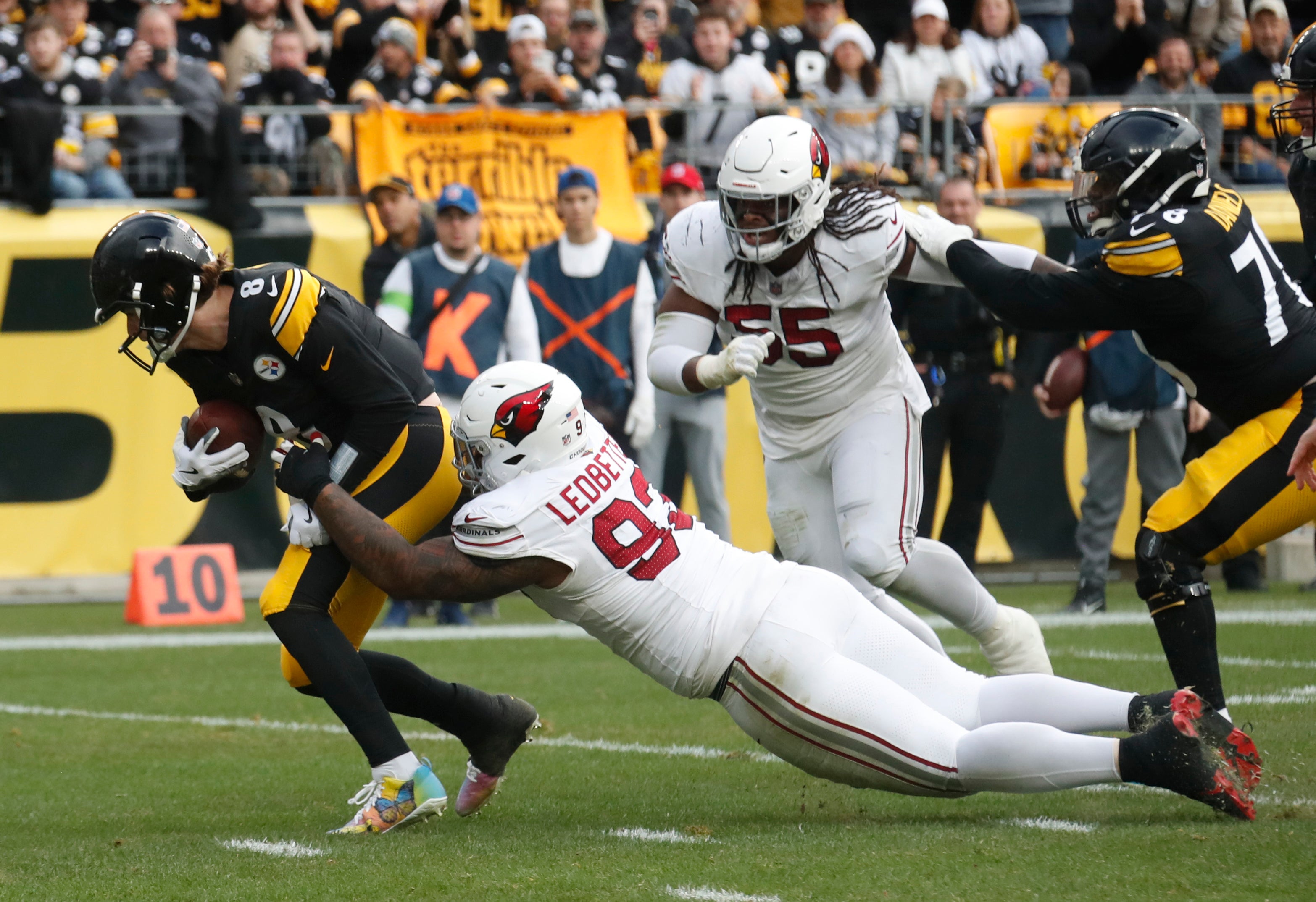 Dec 3, 2023; Pittsburgh, Pennsylvania, USA; Pittsburgh Steelers quarterback Kenny Pickett (8) runs the ball as Arizona Cardinals defensive end Jonathan Ledbetter (93) tackles during the second quarter at Acrisure Stadium. Mandatory Credit: Charles LeClaire-USA TODAY Sports  