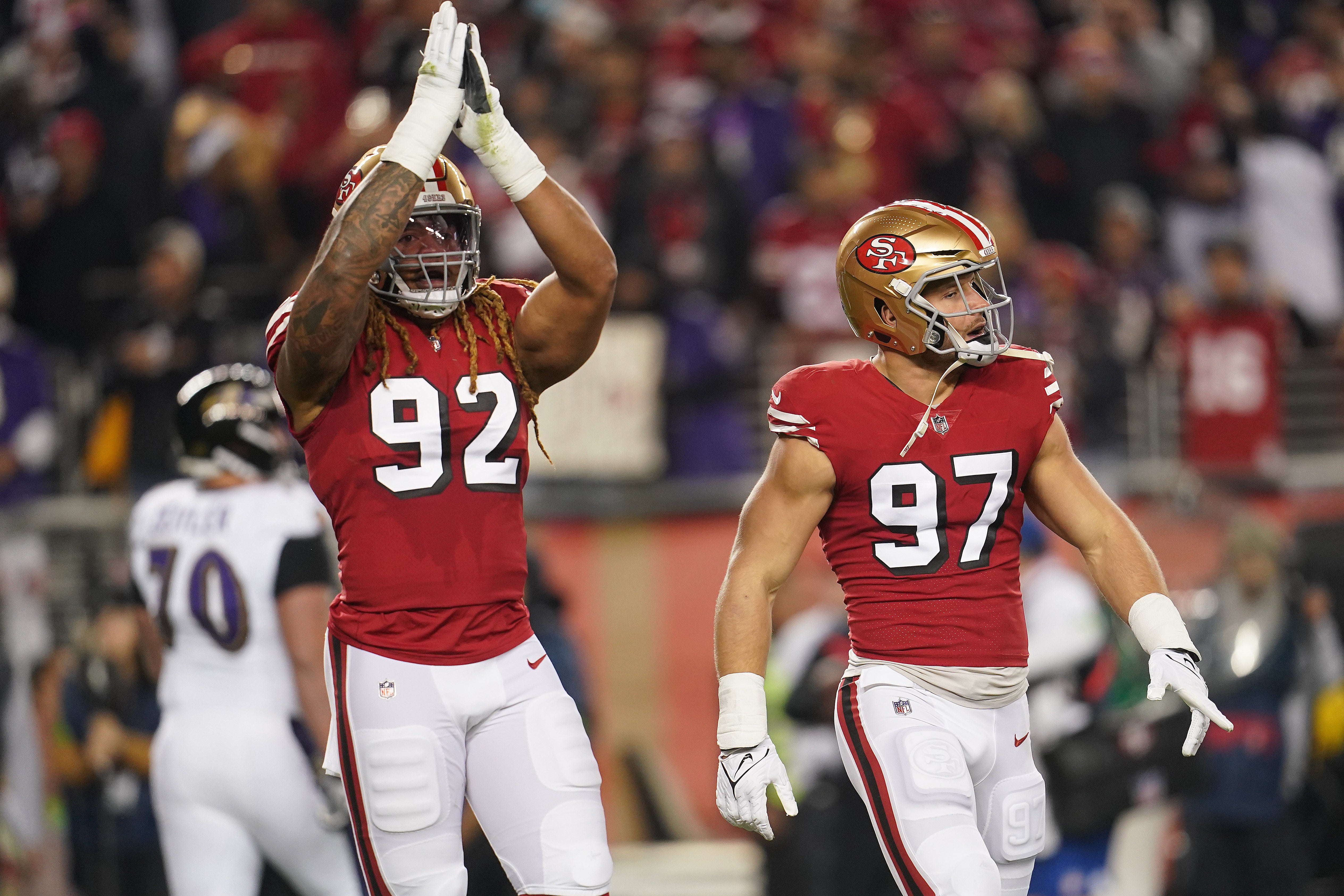 Dec 25, 2023; Santa Clara, California, USA; San Francisco 49ers defensive end Chase Young (92) reacts next to defensive end Nick Bosa (97) after play against the Baltimore Ravens in the first quarter at Levi's Stadium.