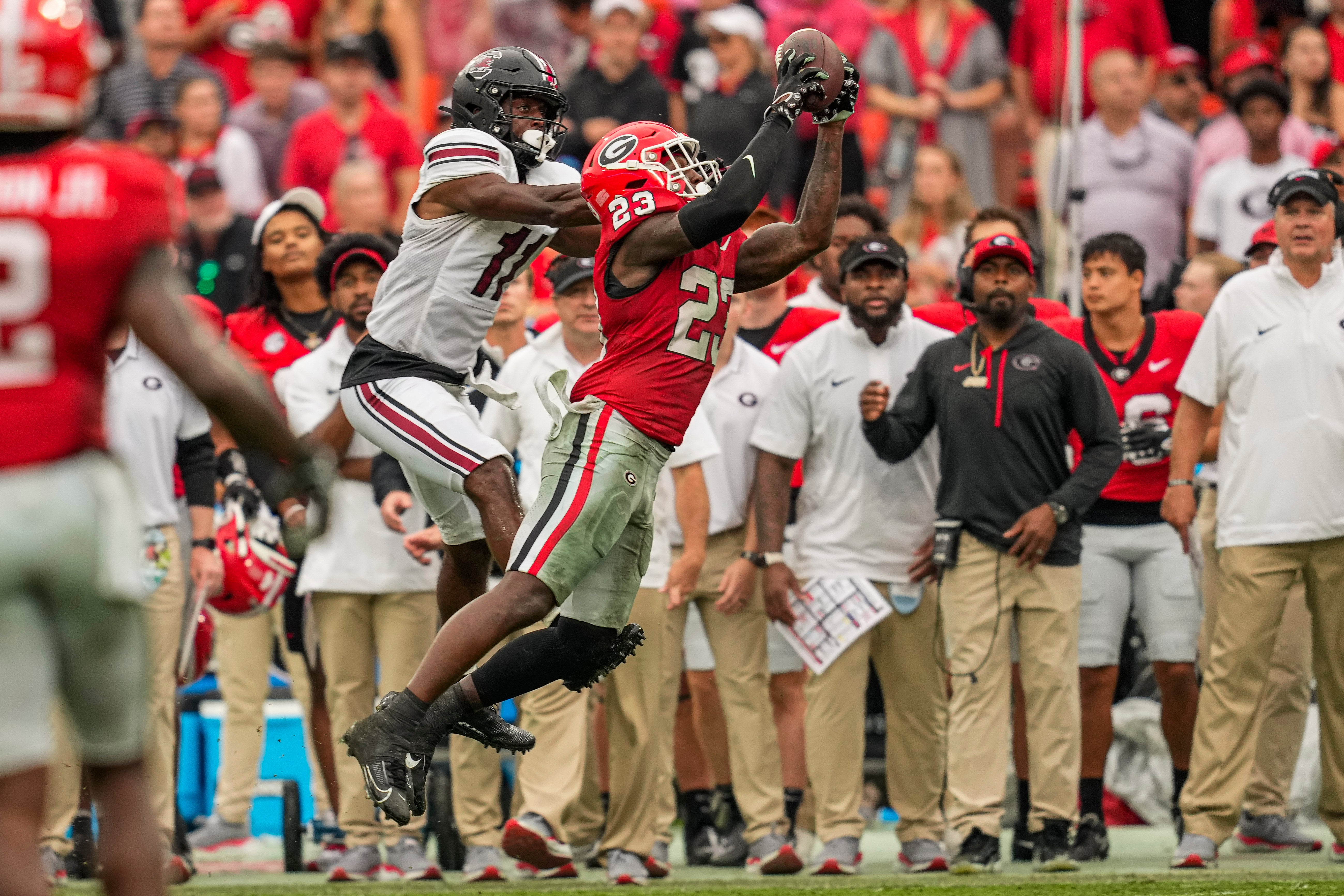 Sep 16, 2023; Athens, Georgia, USA; Georgia Bulldogs defensive back Tykee Smith (23) intercepts a pass in front of South Carolina Gamecocks wide receiver Eddie Lewis (11) during the second half at Sanford Stadium.