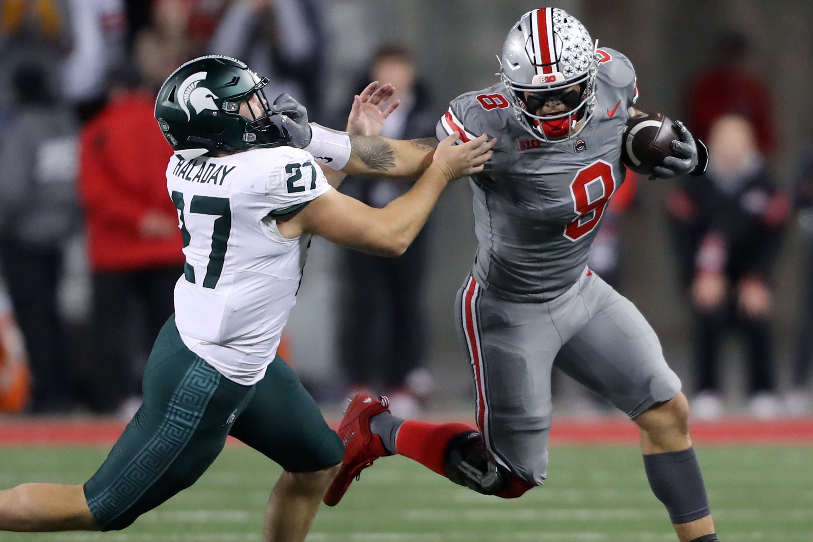 Nov 11, 2023; Columbus, Ohio, USA; Ohio State Buckeyes tight end Cade Stover (8) catches the football as Michigan State Spartans linebacker Cal Haladay (27) makes the tackle during the first quarter at Ohio Stadium.