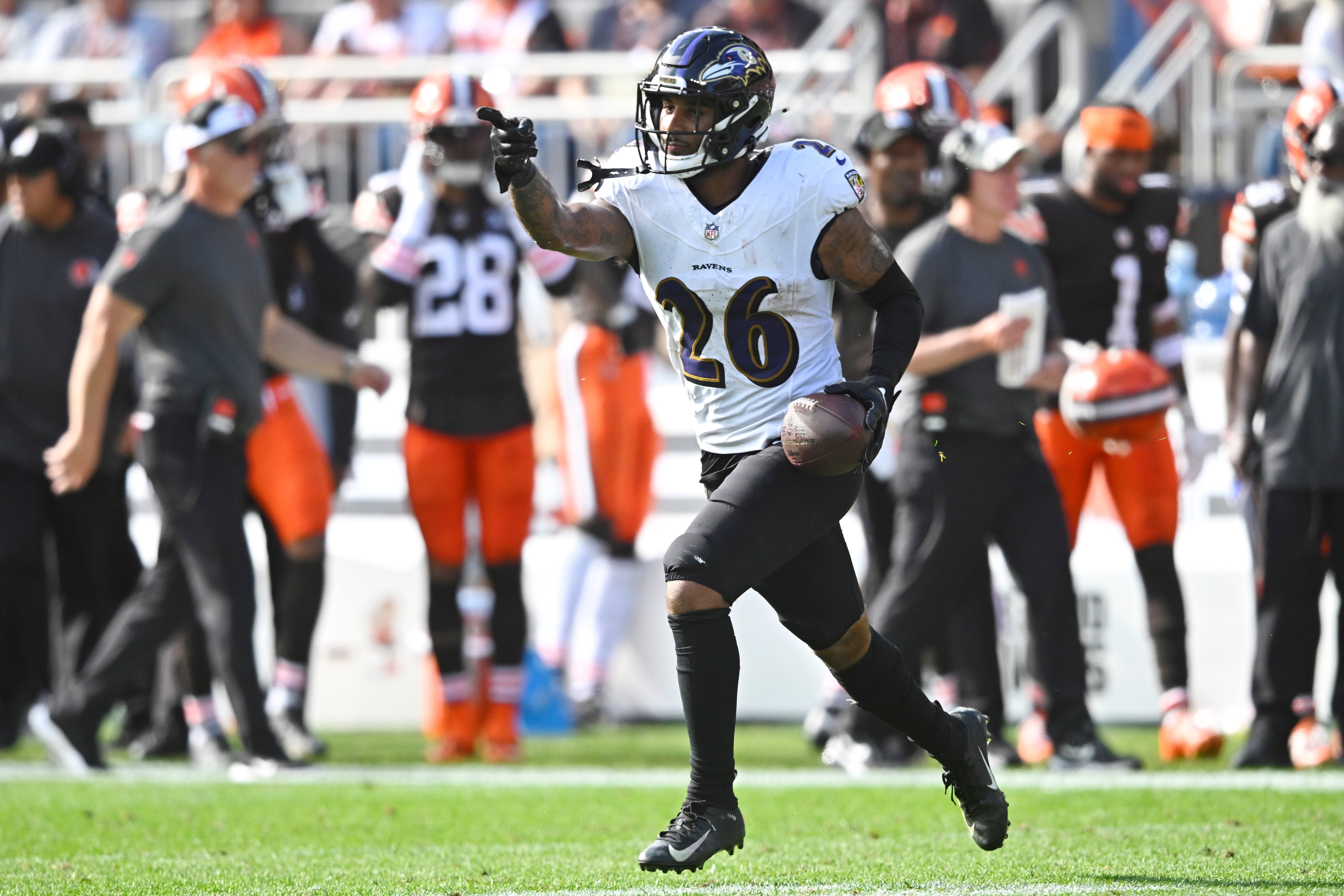 Oct 1, 2023; Cleveland, Ohio, USA; Baltimore Ravens safety Geno Stone (26) celebrates after intercepting a pass in the first quarter against the Cleveland Browns at Cleveland Browns Stadium.