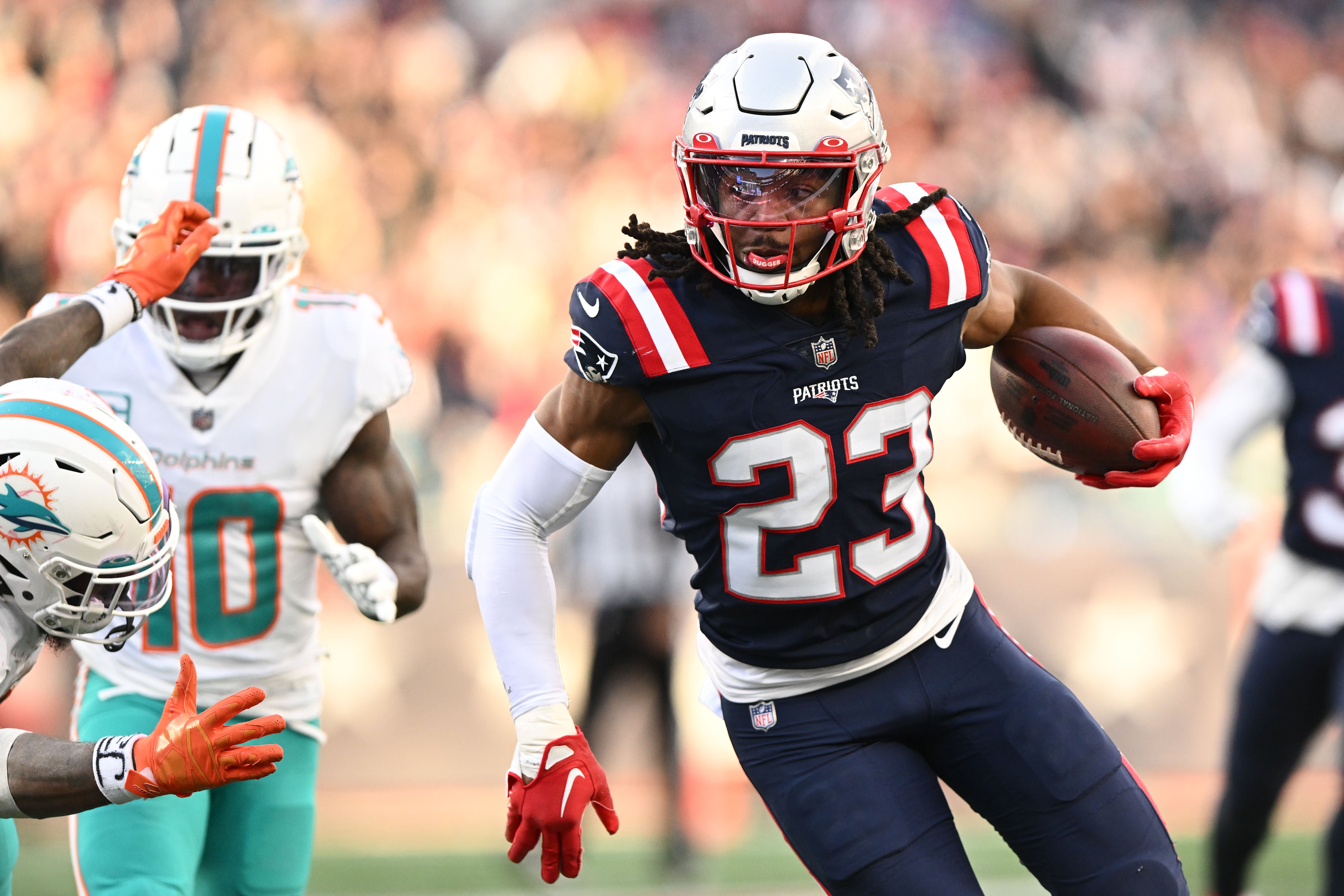 Jan 1, 2023; Foxborough, Massachusetts, USA; New England Patriots safety Kyle Dugger (23) runs for a touchdown after intercepting the ball during the second half of a game against the Miami Dolphins at Gillette Stadium.