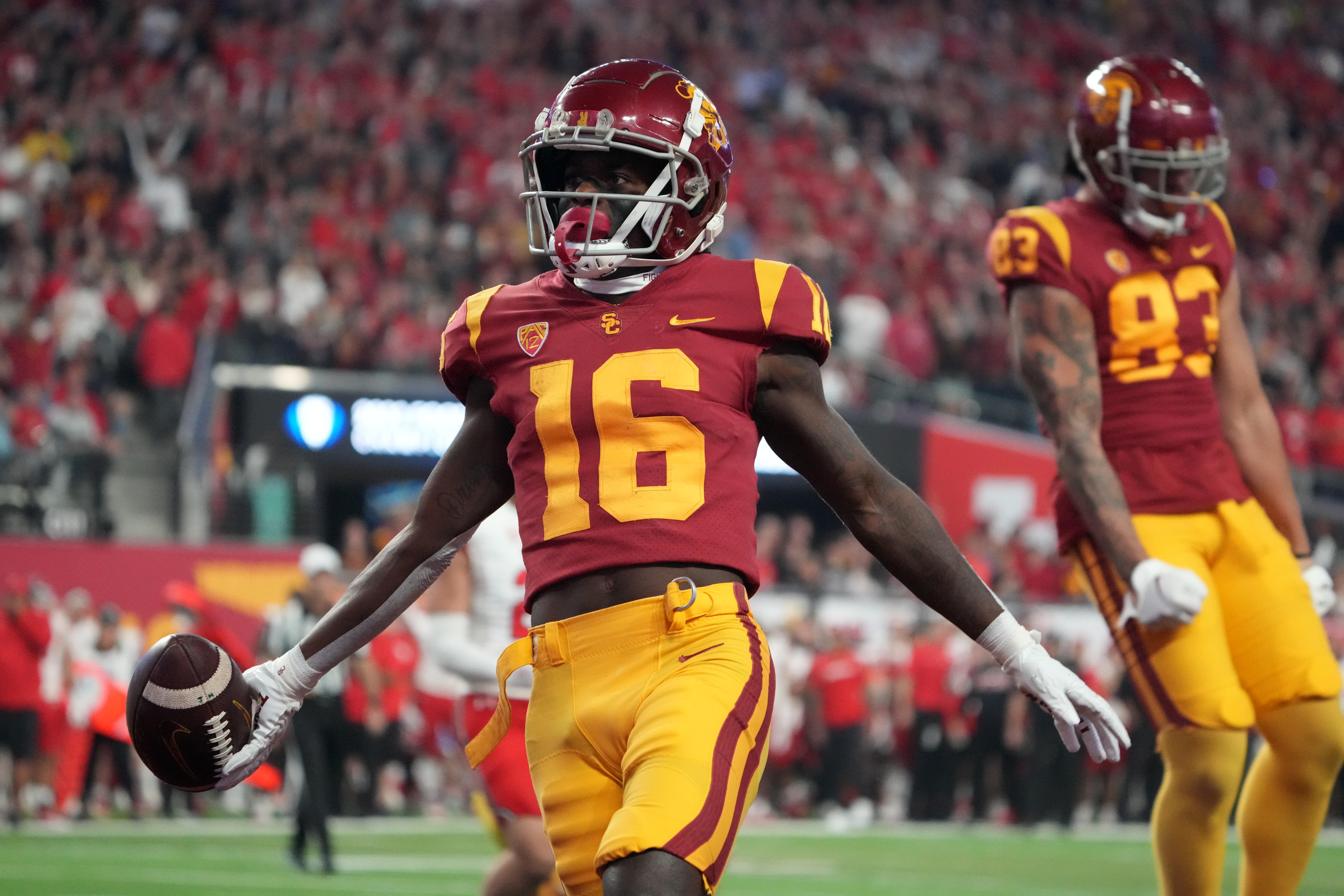 Dec 2, 2022; Las Vegas, NV, USA; Southern California Trojans wide receiver Tahj Washington (16) celebrates after scoring on a 2-yard touchdown reception against the Utah Utes in the first half of the Pac-12 Championship at Allegiant Stadium.