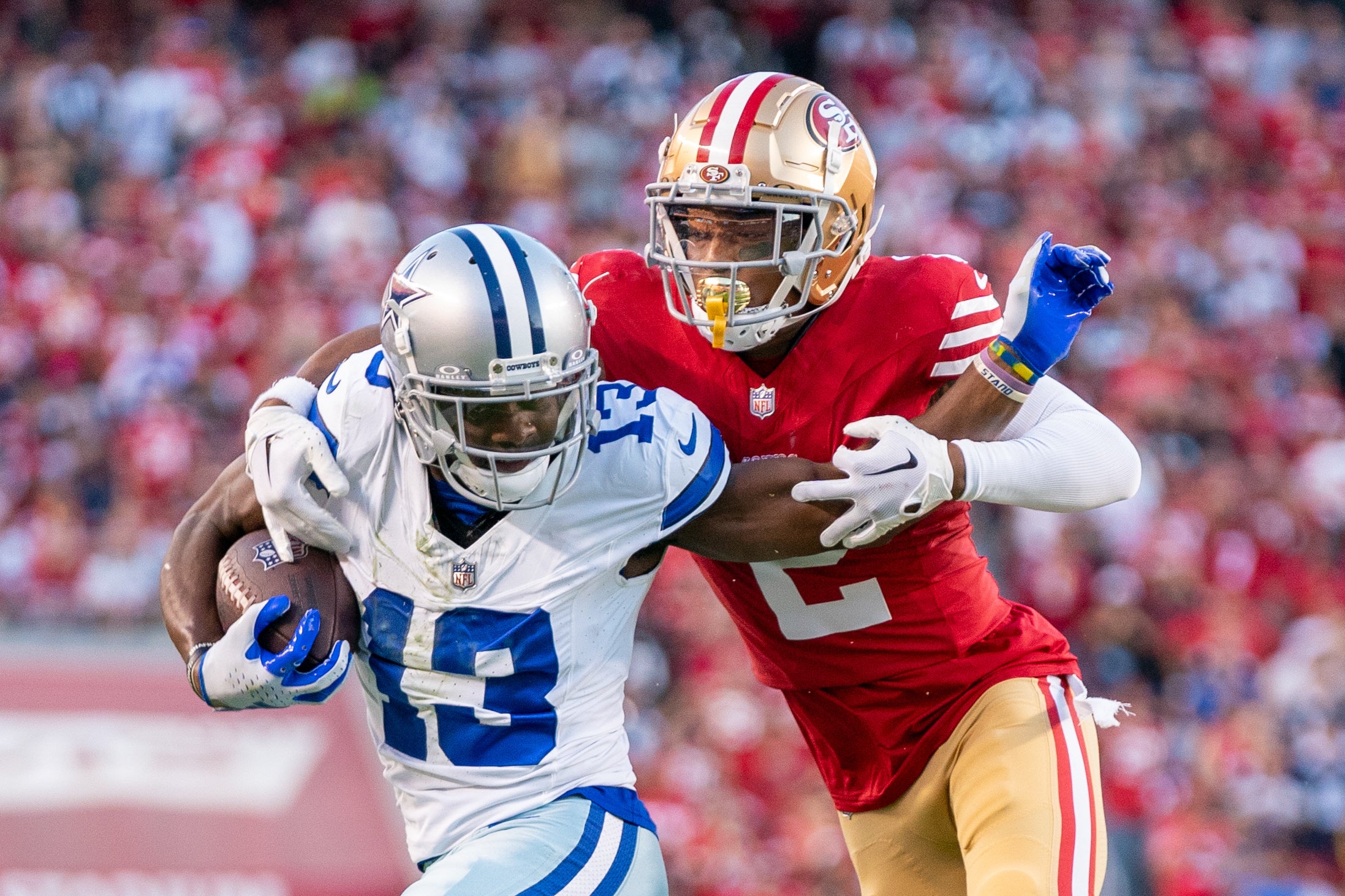 San Francisco 49ers cornerback Deommodore Lenoir (2) tackles Dallas Cowboys wide receiver Michael Gallup (13) during the second quarter at Levi's Stadium.