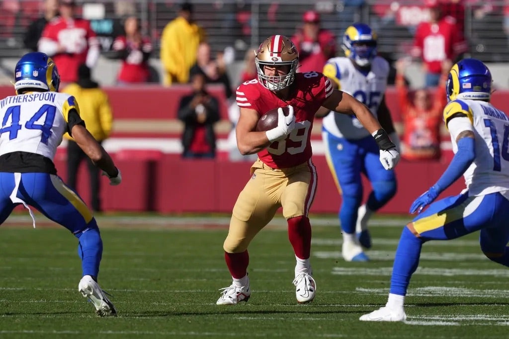 San Francisco 49ers tight end Charlie Woerner (center) runs after a catch against Los Angeles Rams cornerbacks Ahkello Witherspoon (44) and Cobie Durant (14) during the first quarter.