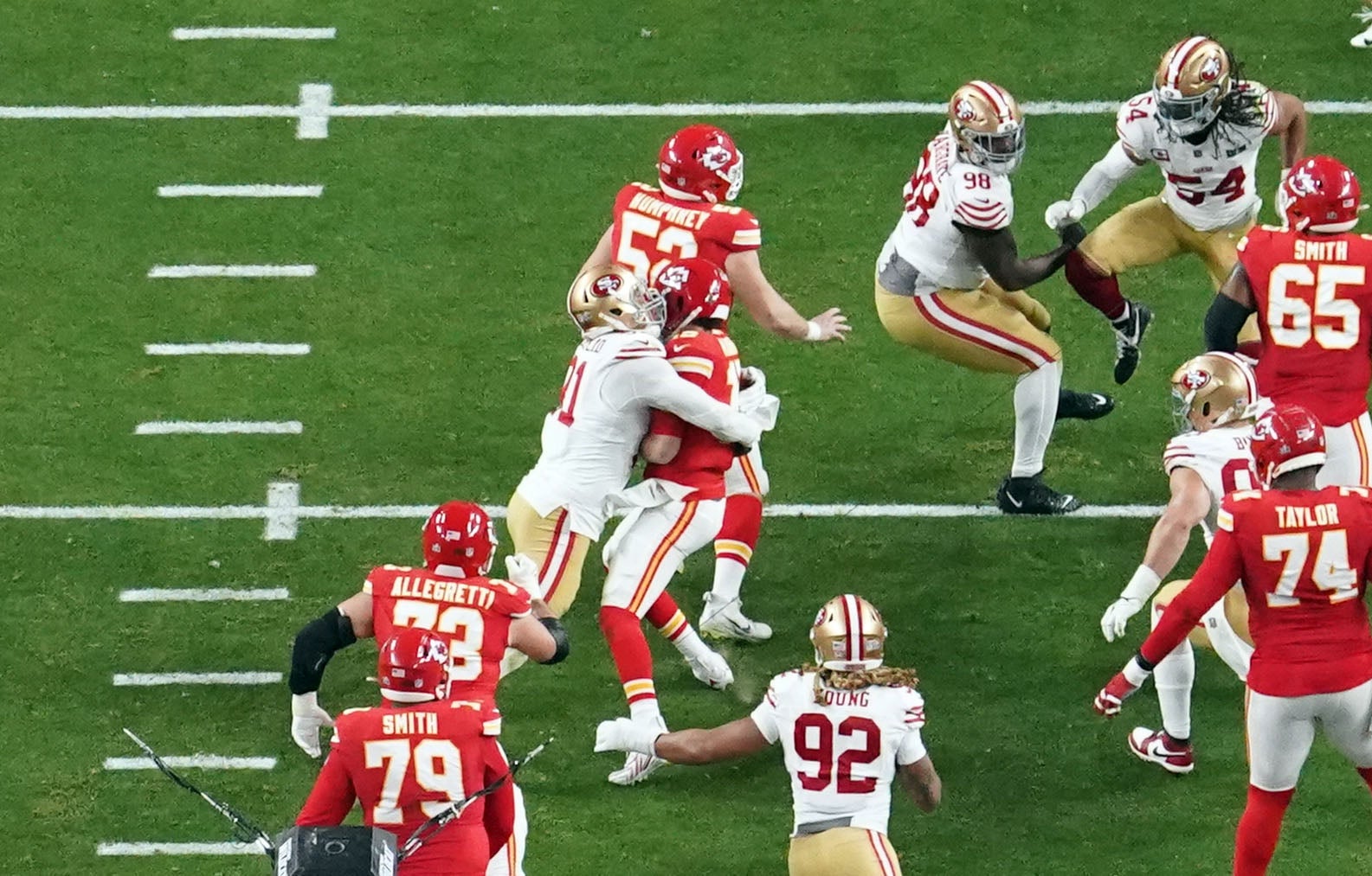 Feb 11, 2024; Paradise, Nevada, USA; Kansas City Chiefs quarterback Patrick Mahomes (15) is sacked by San Francisco 49ers defensive end Arik Armstead (91) during the second quarter in Super Bowl LVIII at Allegiant Stadium.